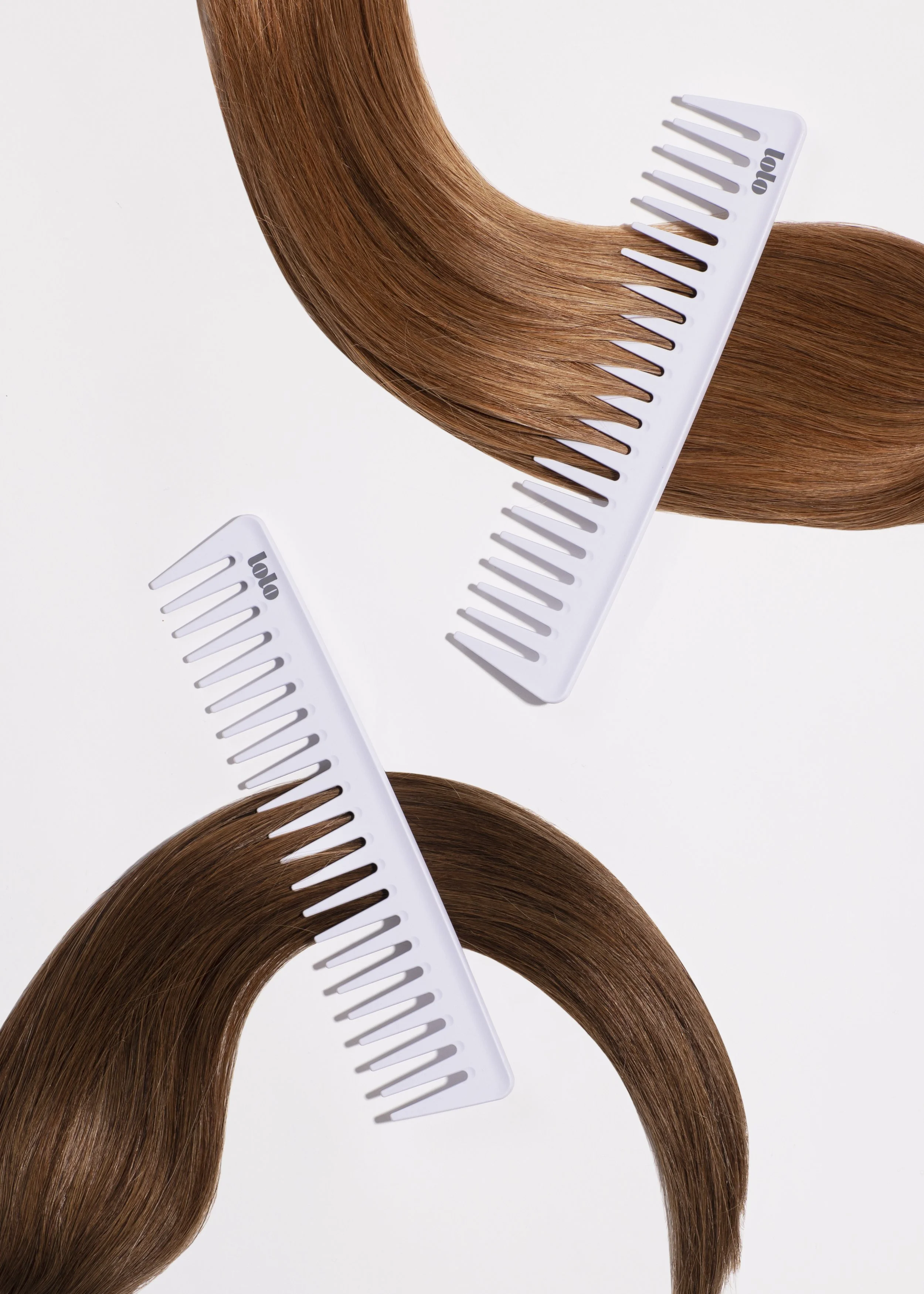 Two brown hair weaves with white hair combs on a white background, arranged in a mirrored pattern.
