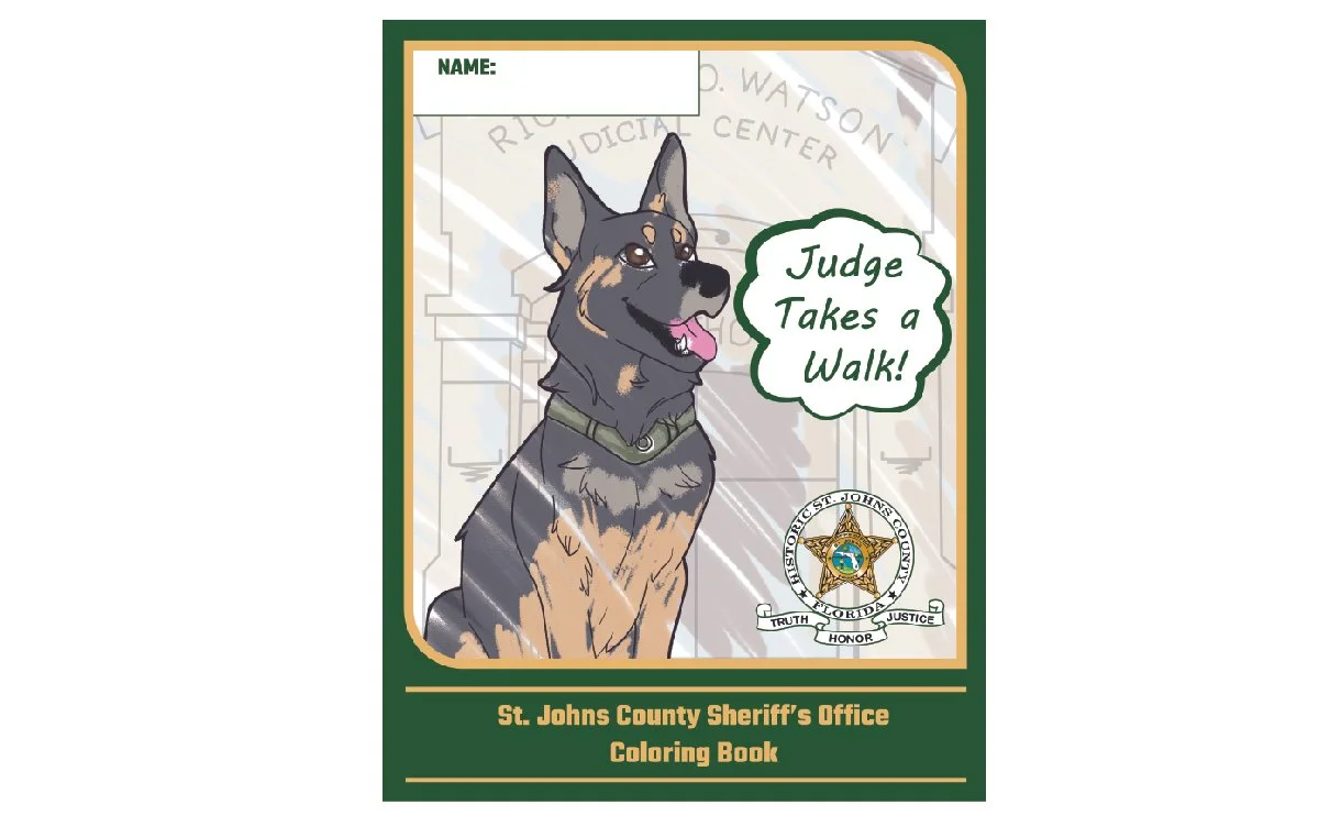 Cover of a coloring book titled 'St. Johns County Sheriff's Office Coloring Book.' Contains an illustration of a police dog with a speech bubble saying, 'Judge Takes a Walk!' and the sheriff's badge near the bottom right.