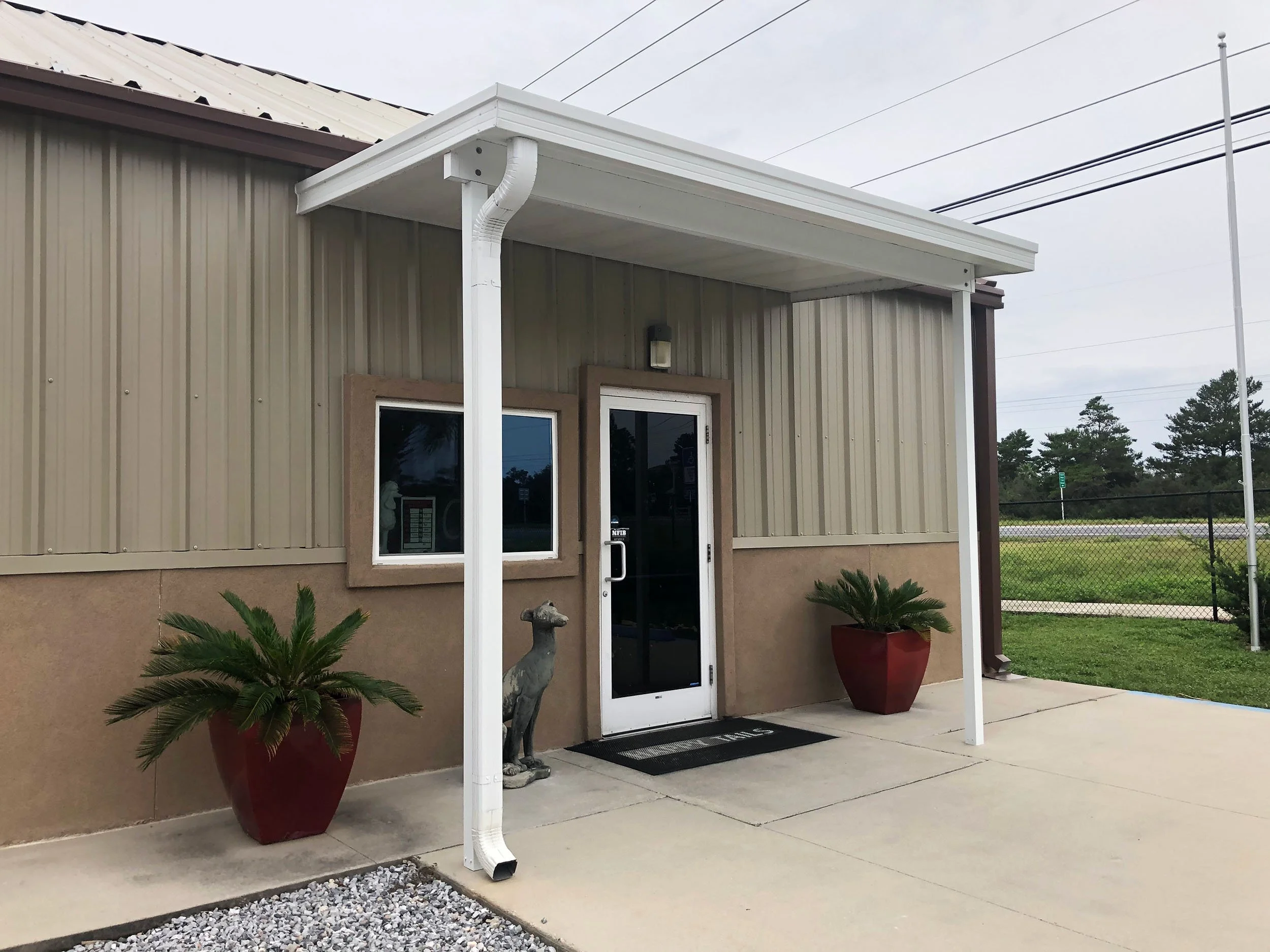 Storefront awning designed to improve curb appeal and help define the business entrance.