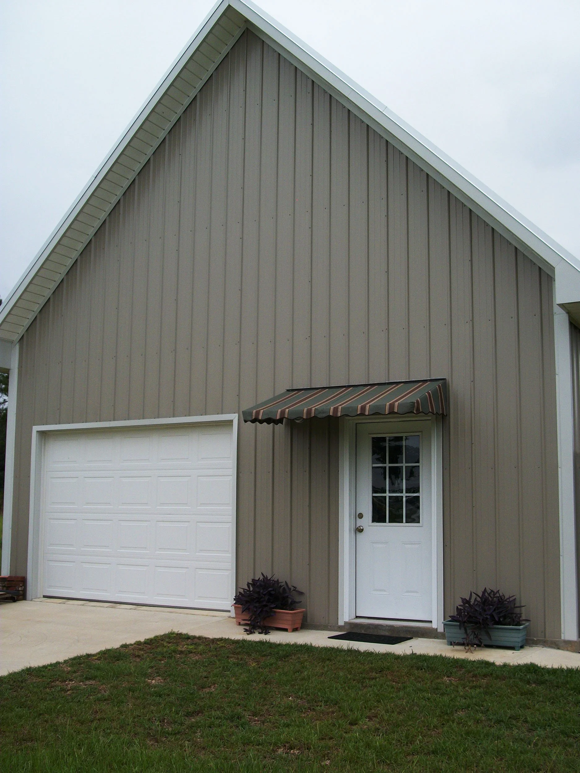 Fabric door awning installed to reduce sun and rain exposure and enhance the home exterior.