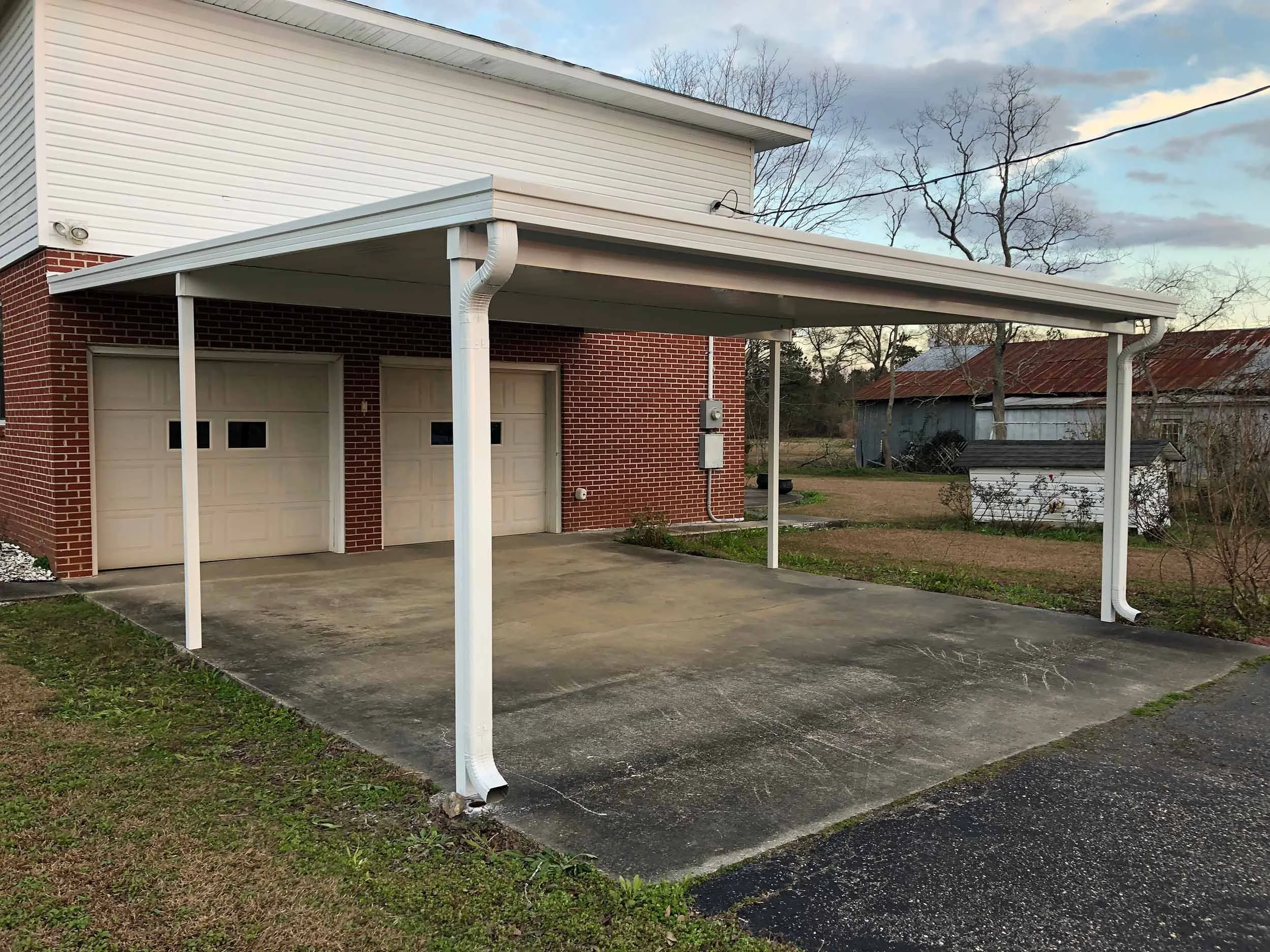 Custom vehicle shelter designed to protect against sun and rain.