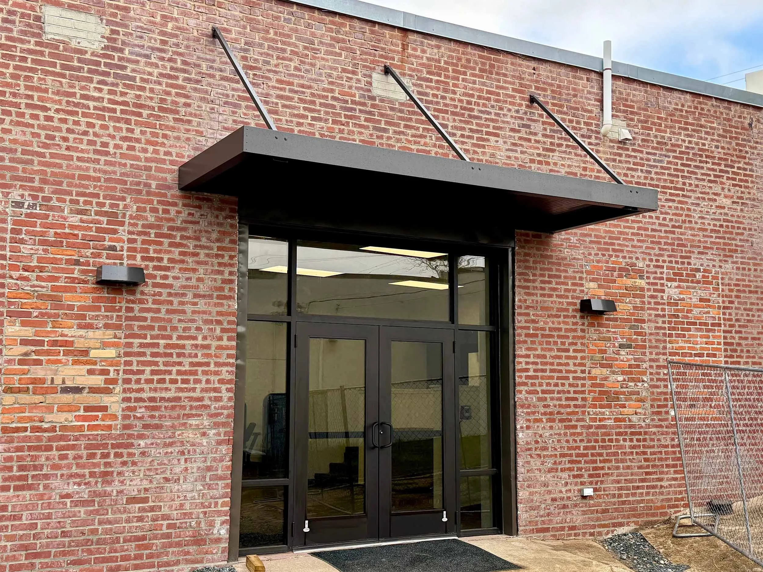 Commercial entrance awning installed to create a more welcoming business exterior.