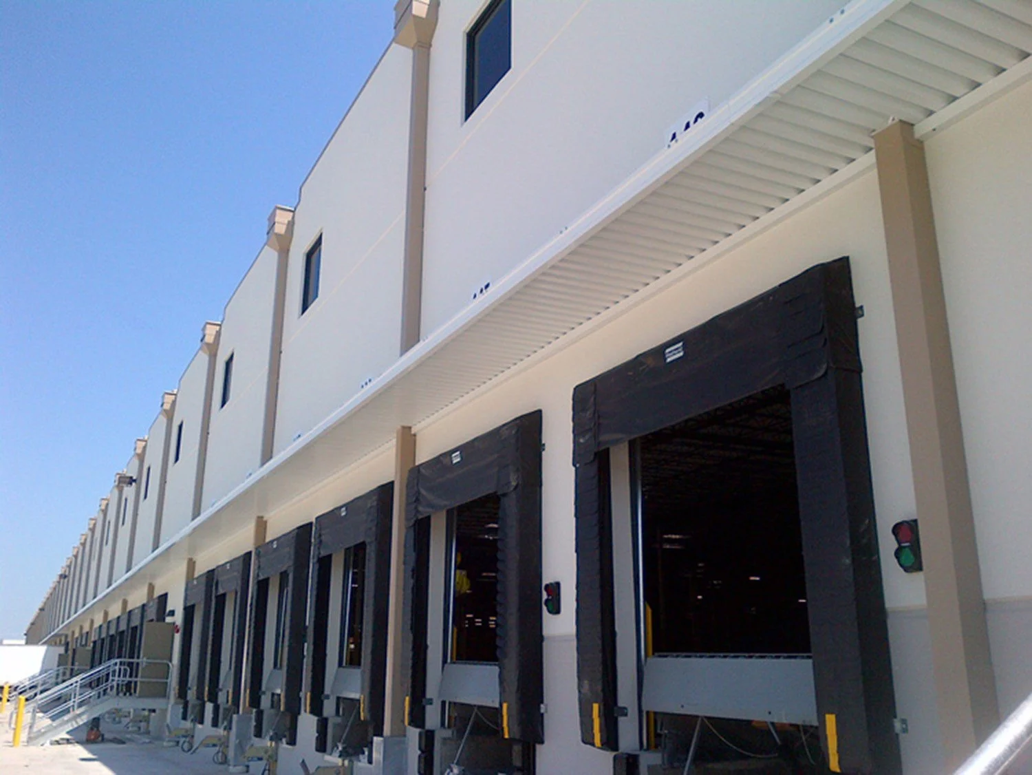 Awning system installed over a commercial entry for shade and weather protection.