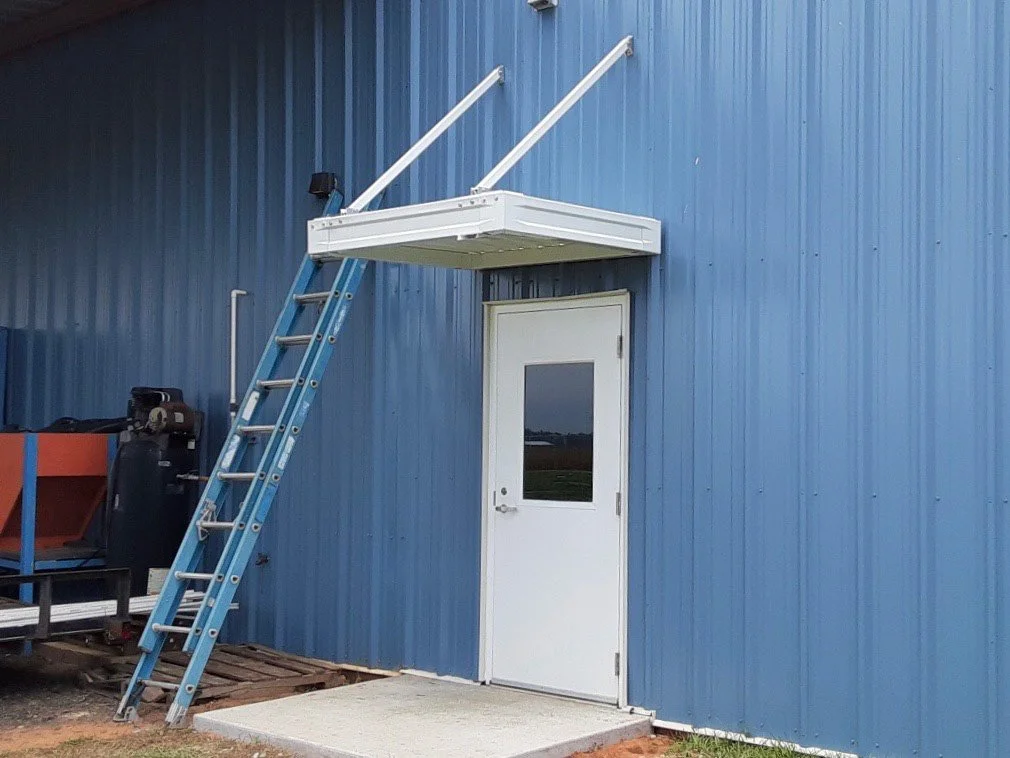 Awning system installed over a commercial entry for shade and weather protection.