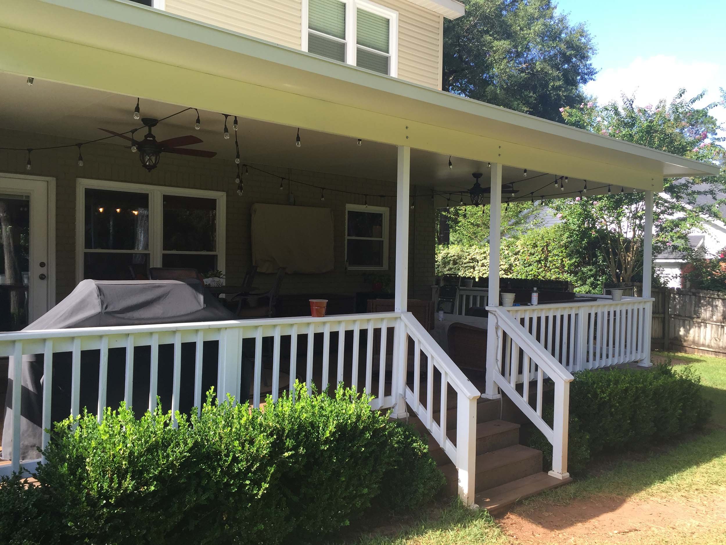 Custom awning installed over a residential patio for added protection.
