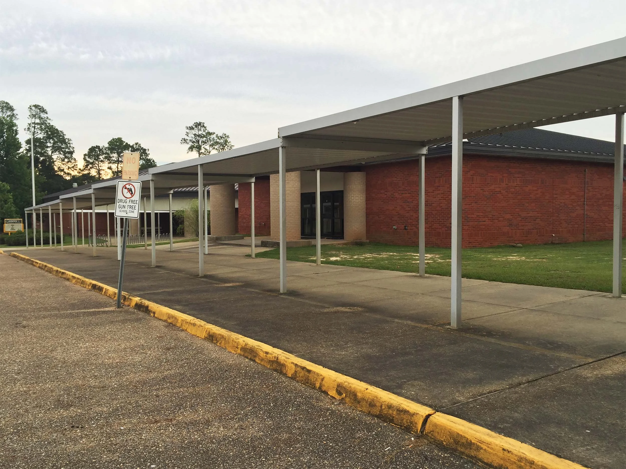 Custom walkway cover designed to protect entrances, sidewalks, and outdoor corridors.
