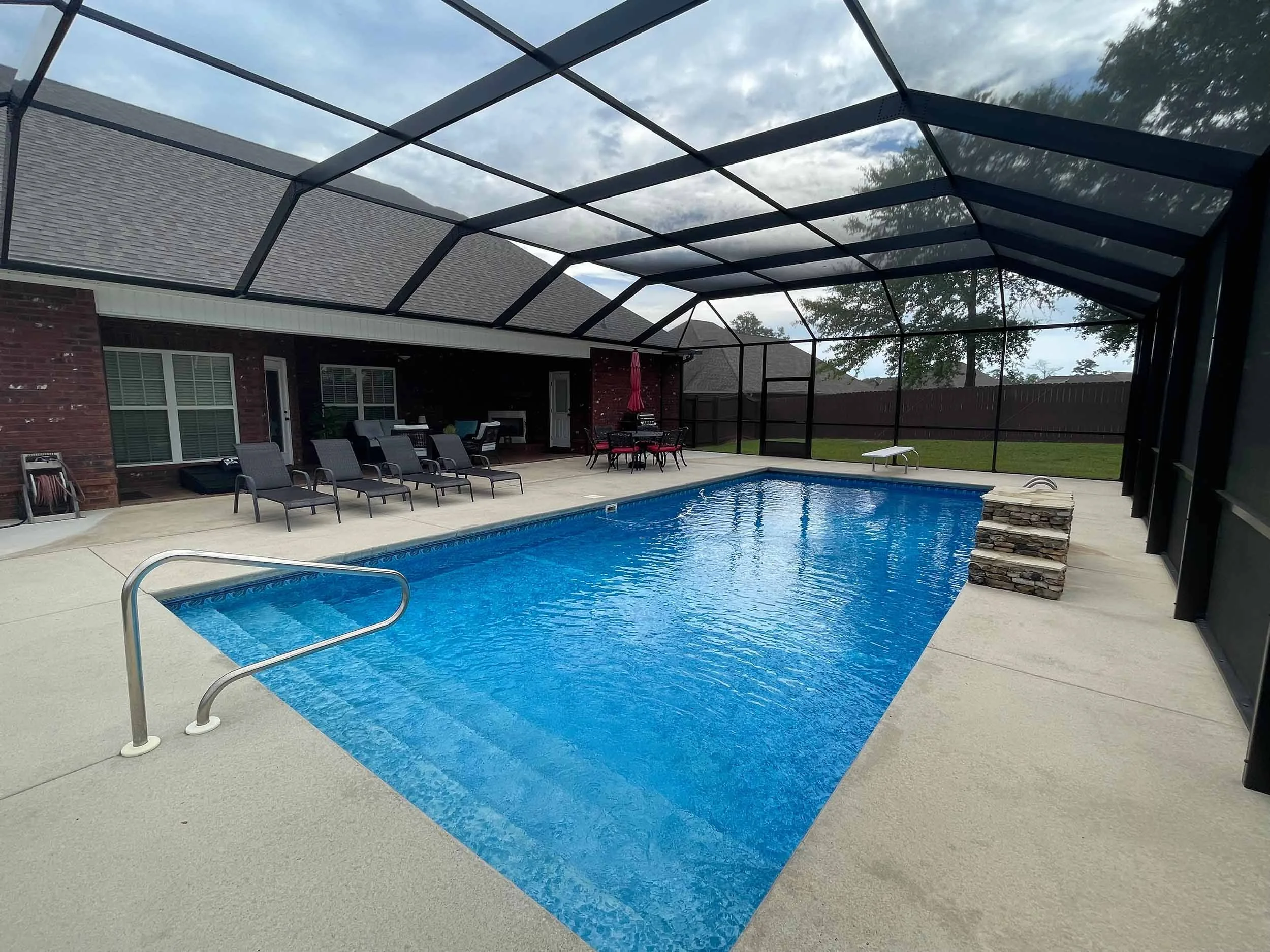 Custom residential pool cage designed to enhance poolside living and relaxation.