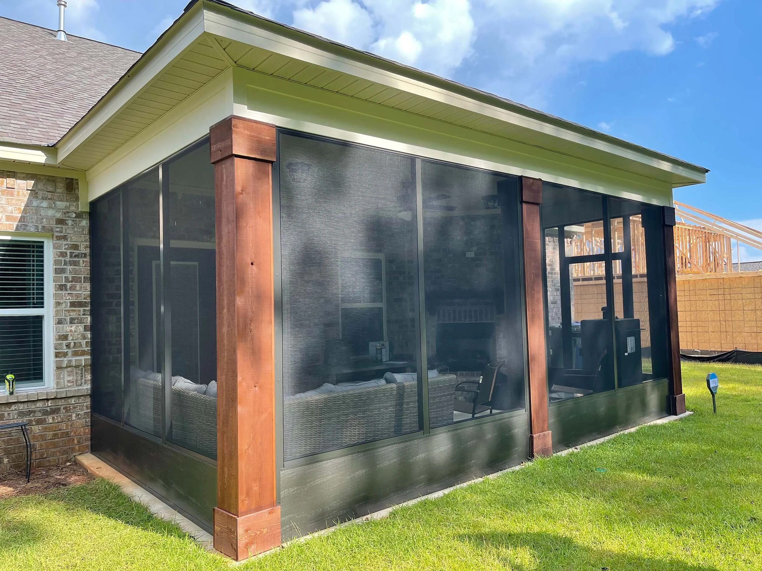Screenroom installation creating a comfortable transition between home and yard.