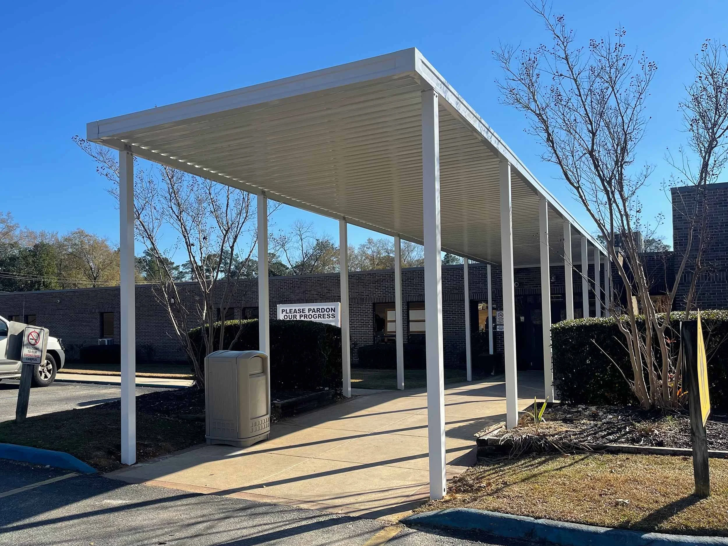 Commercial covered walkway installation for a business or institutional property.