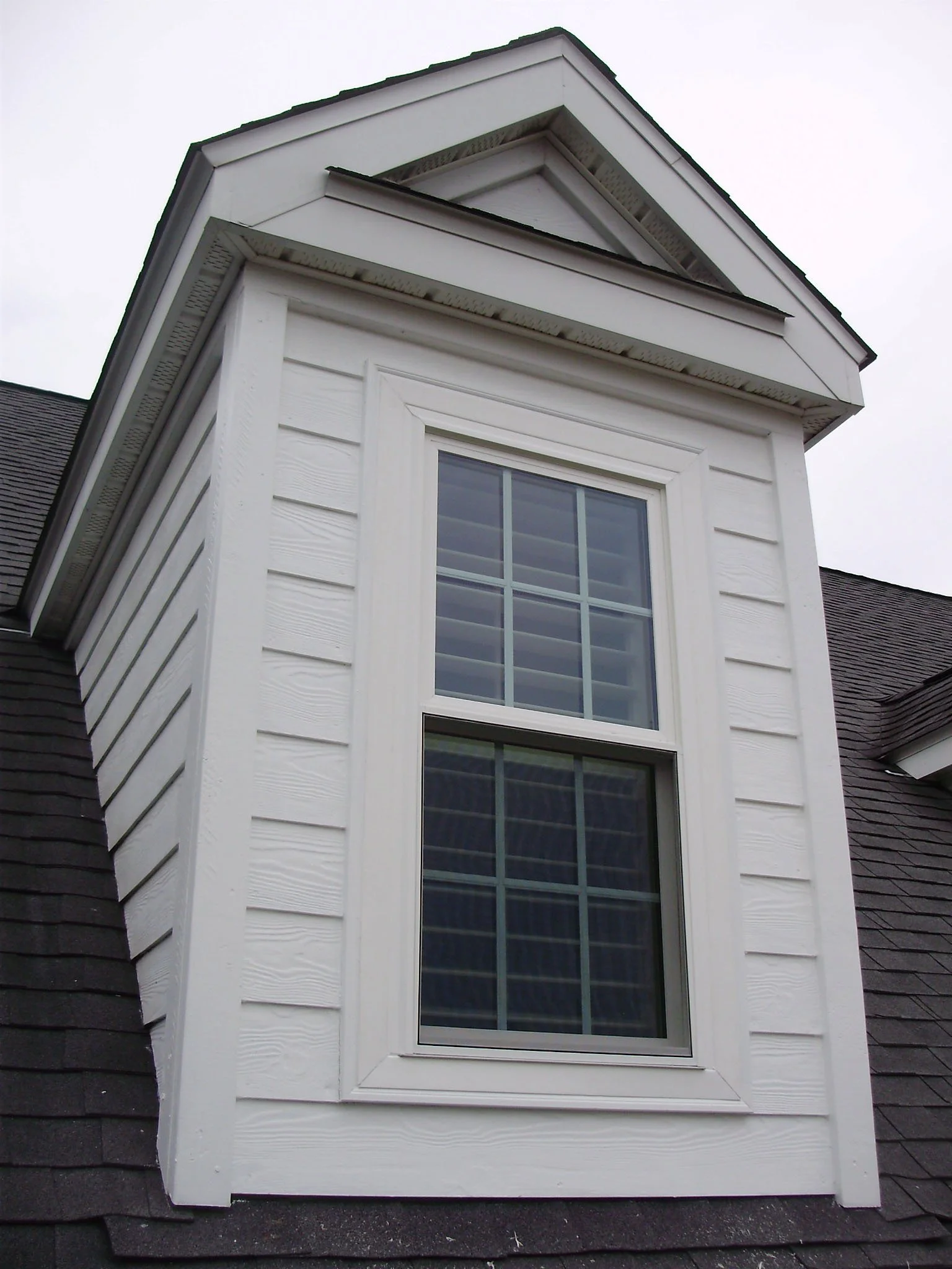 White replacement windows installed on a traditional Southern home.