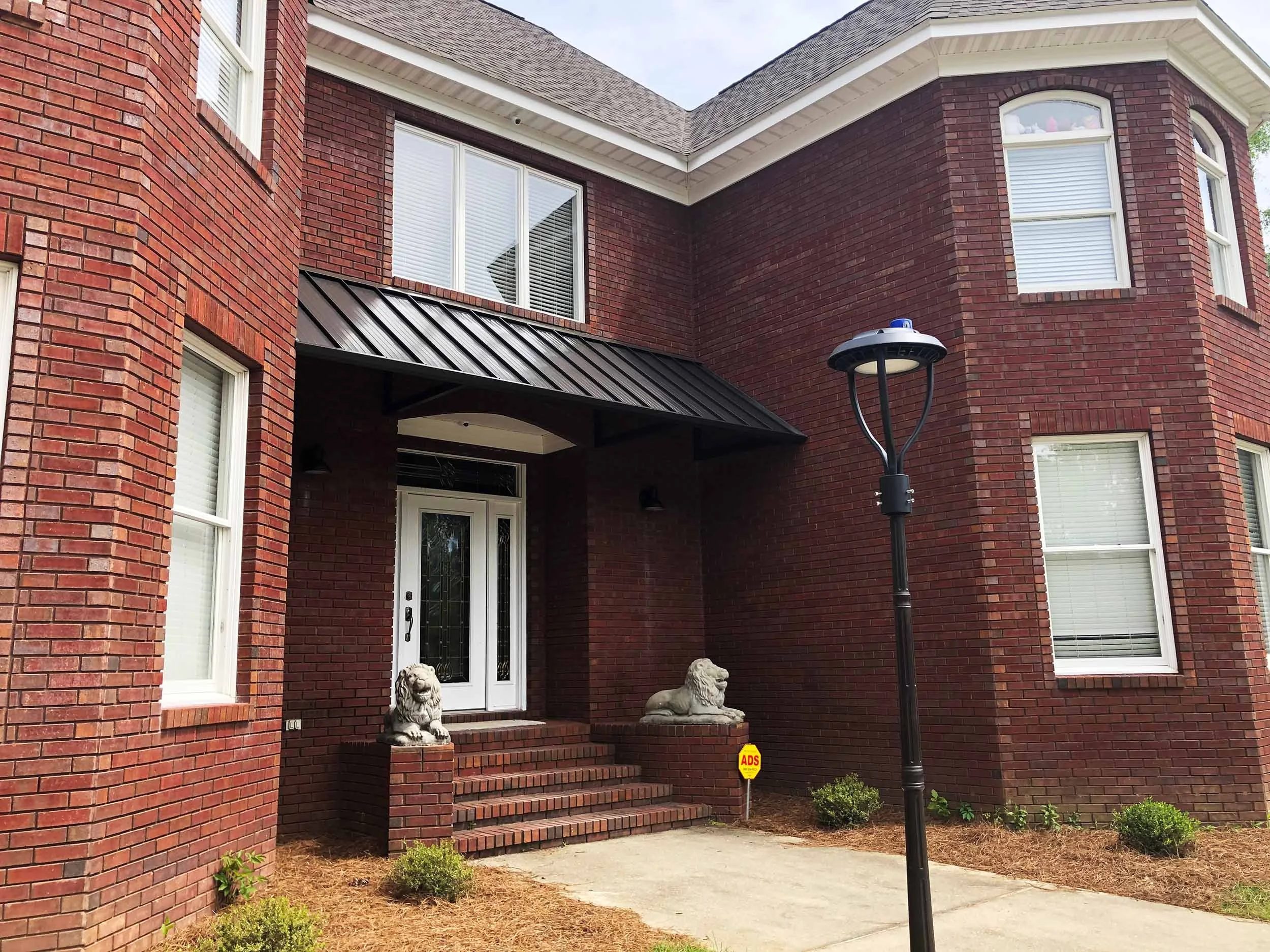 Metal door awning installed to add weather protection and exterior style.
