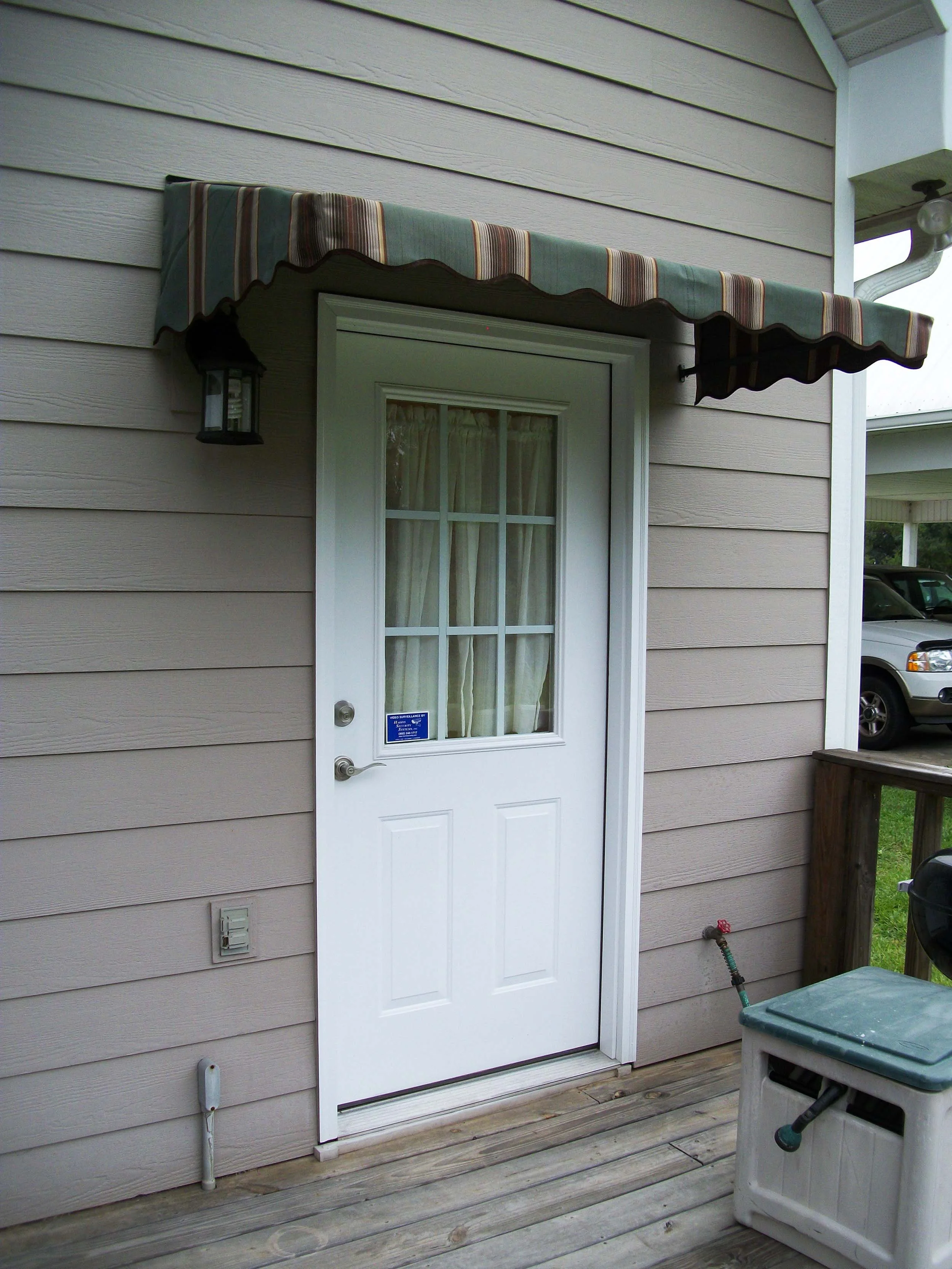Residential awning over an exterior door by Hathcock Home Services.
