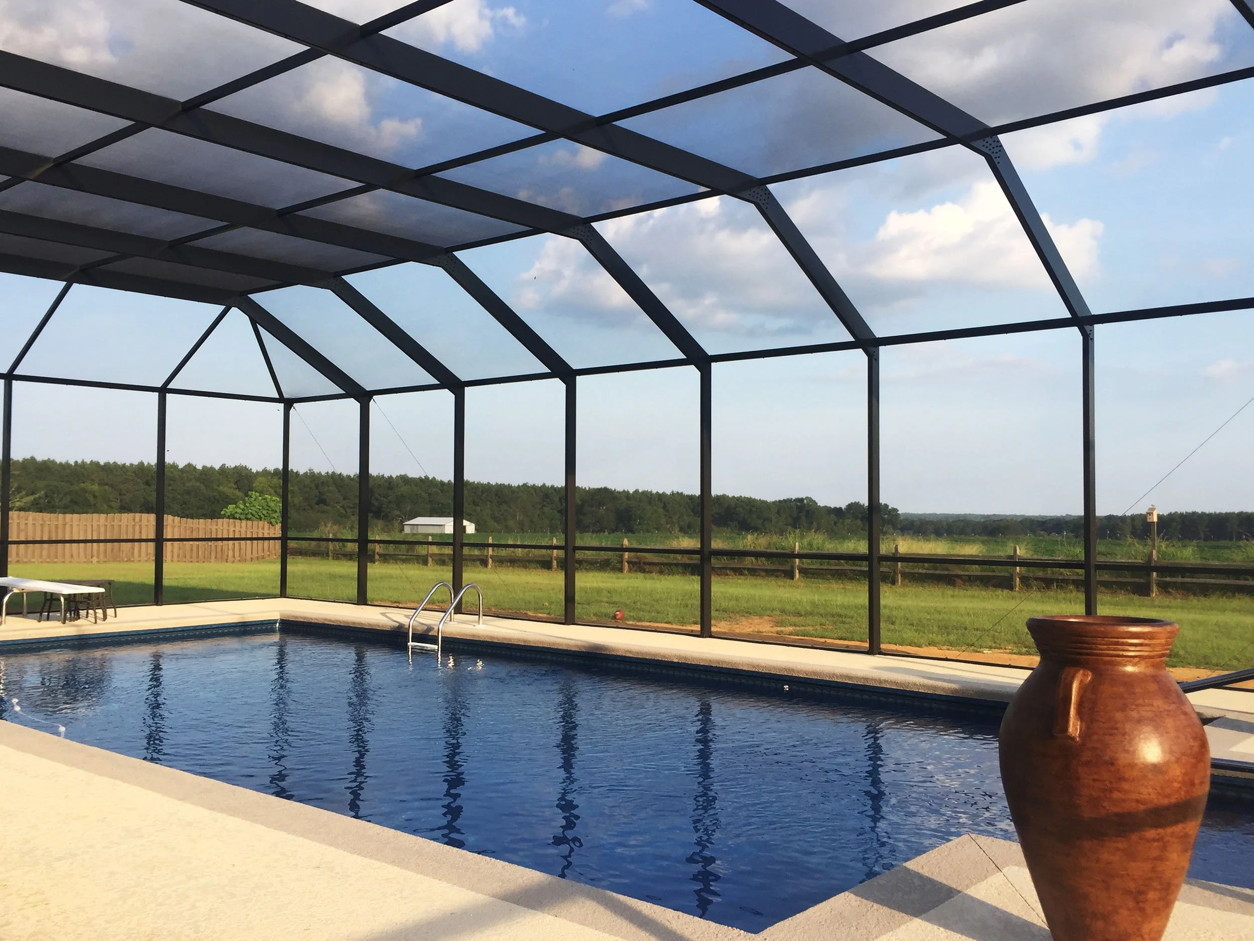 Residential screened pool enclosure for a cleaner, more comfortable backyard space.