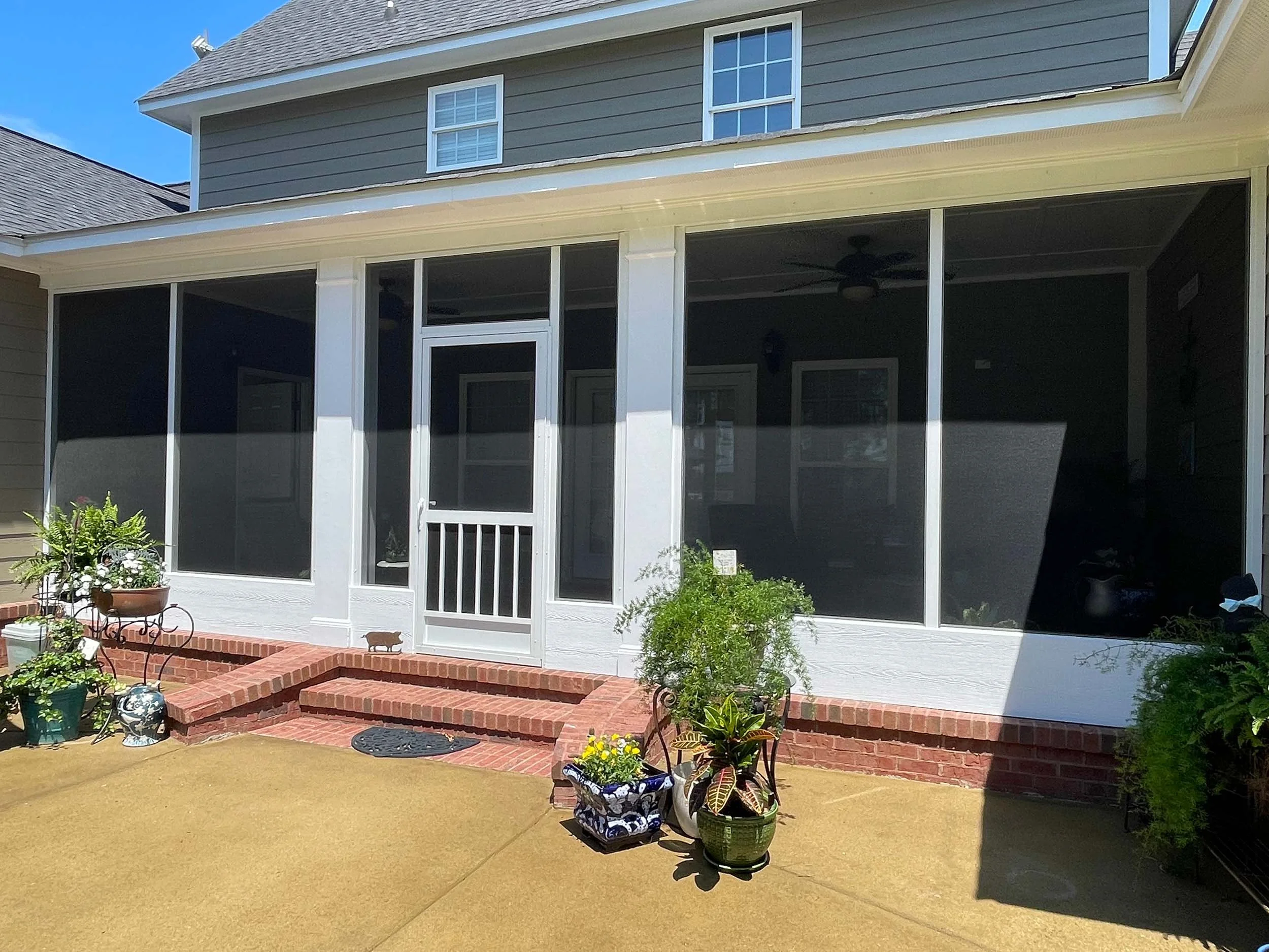 Enclosed screenroom addition for a comfortable residential outdoor space.