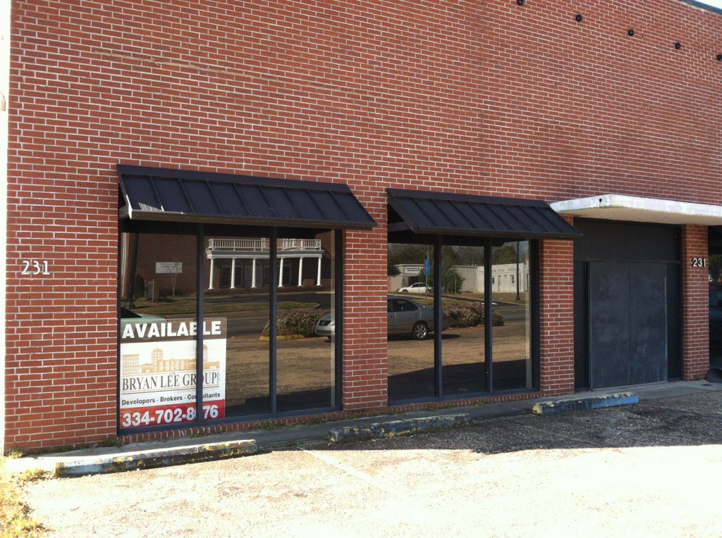Commercial canopy installation designed to protect walkways, windows, and entry areas.