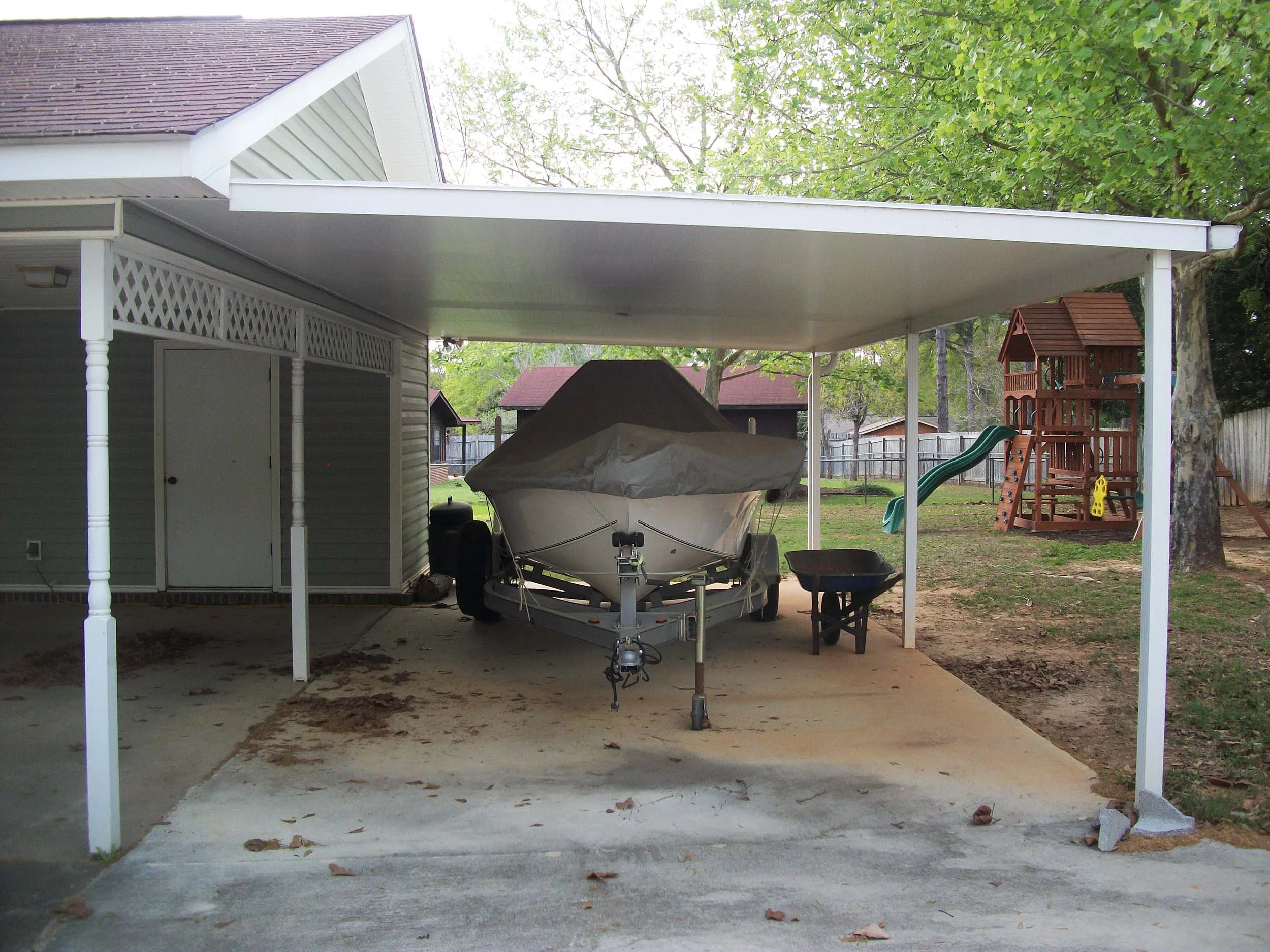 Custom carport built to create a practical covered parking space for a boat.