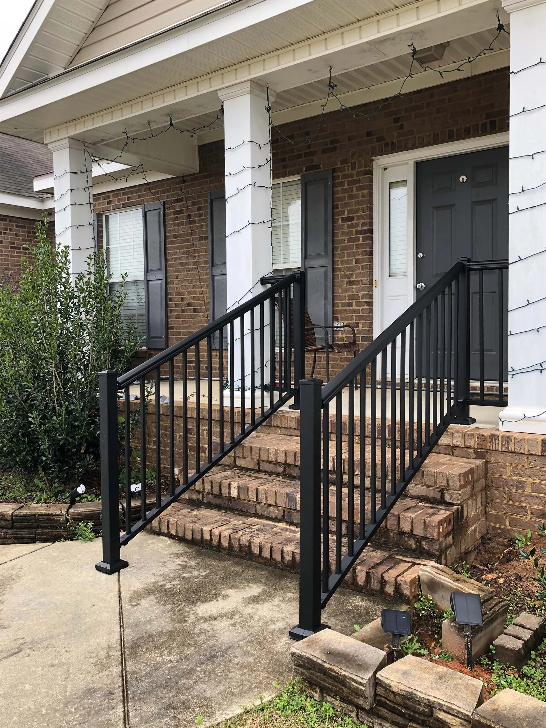 Outdoor stair railing installed for improved stability and curb appeal.