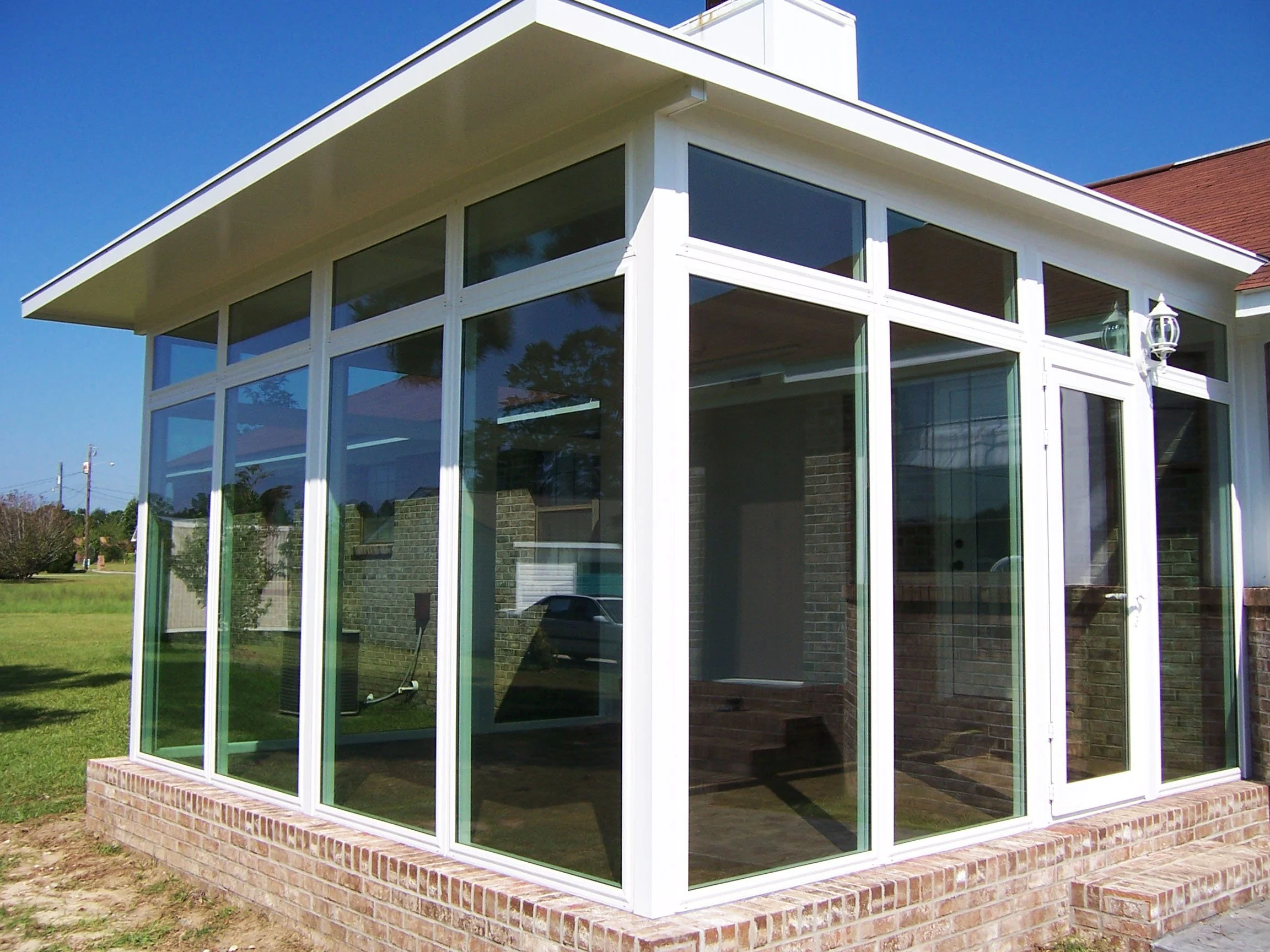 Custom sunroom featuring wide windows and a comfortable view of the outdoors.
