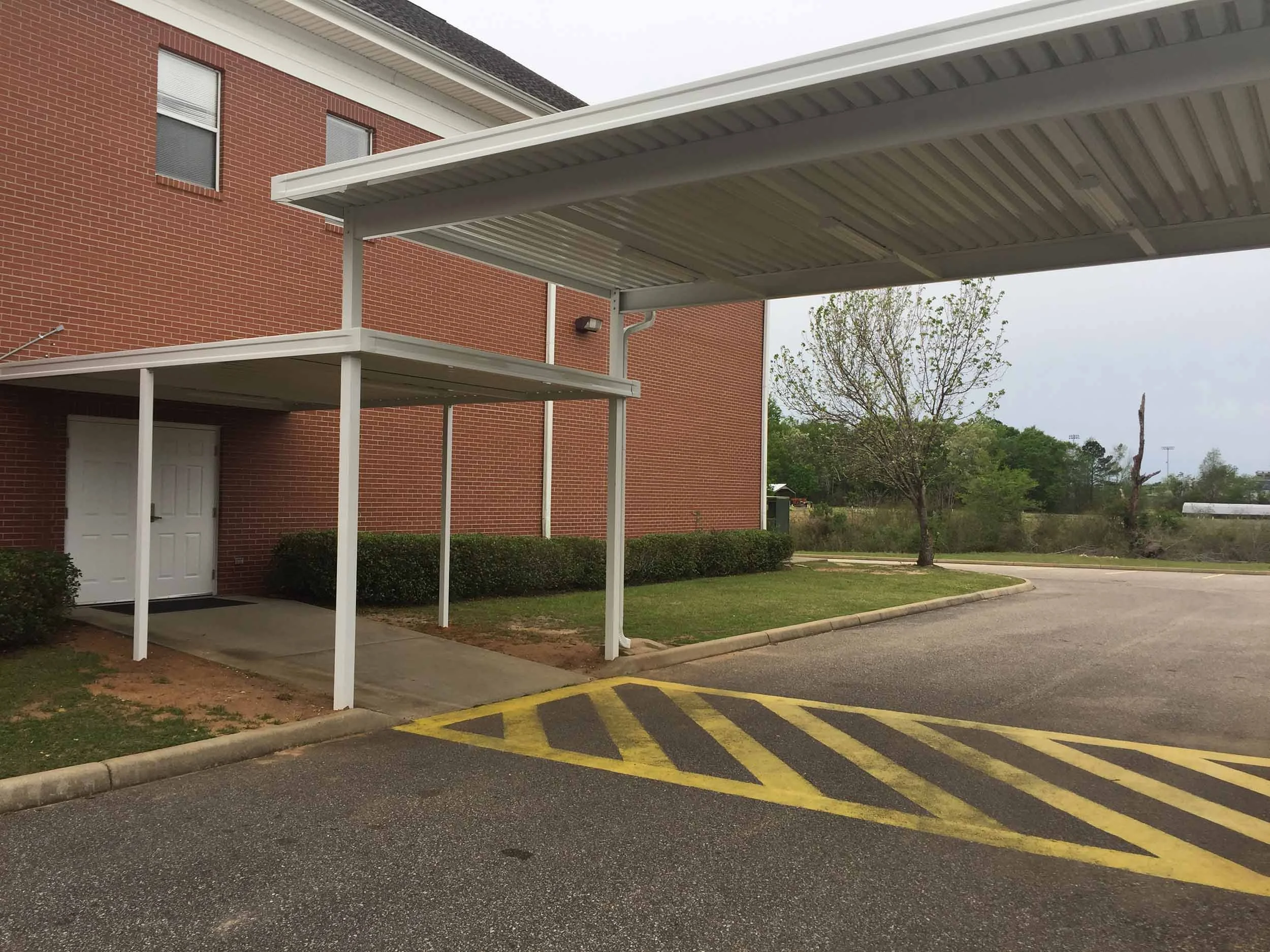 Custom commercial walkway cover built to provide shade, shelter, and reliable access.
