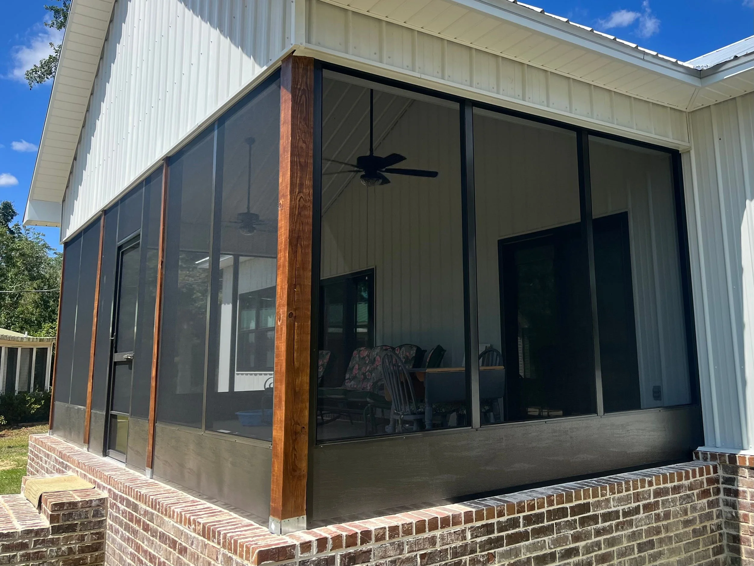 Residential screened porch designed for comfort, airflow, and outdoor views.