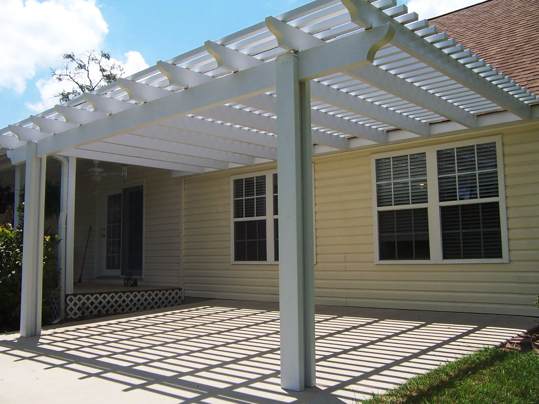 Custom pergola addition creating a shaded space for outdoor seating.