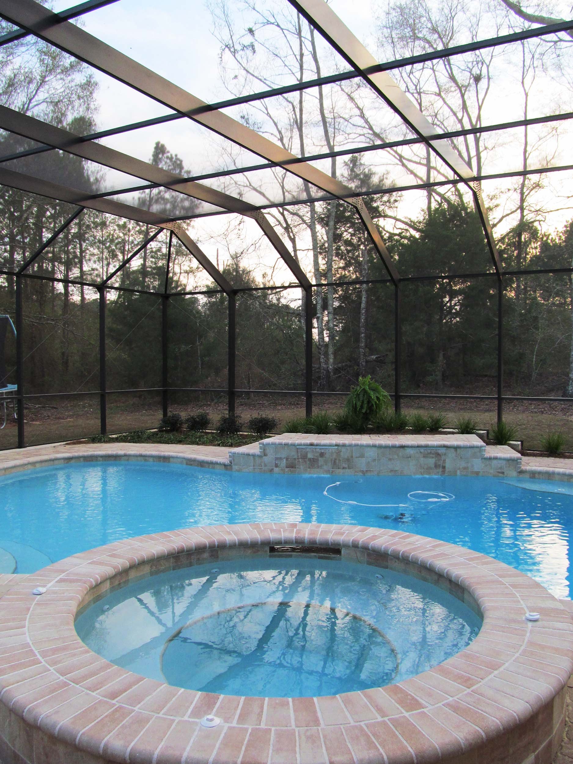 Pool enclosure installation for enjoying a backyard pool with added protection.