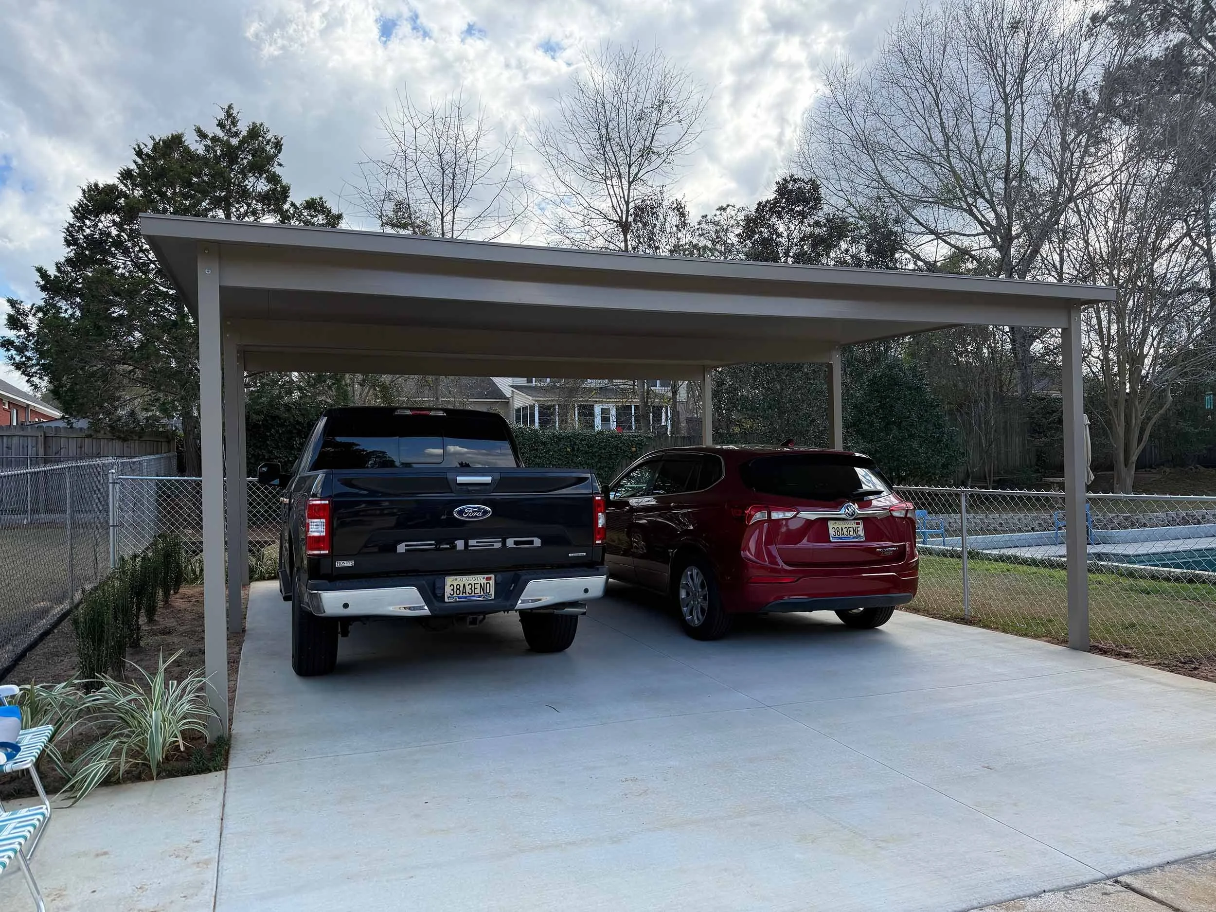 Durable covered carport structure installed for a residential property.