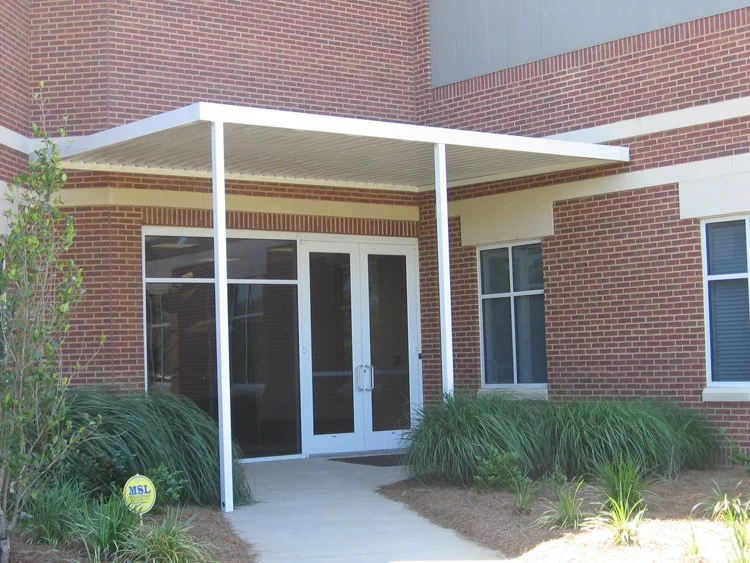 Commercial building awning installed for improved comfort and customer access.