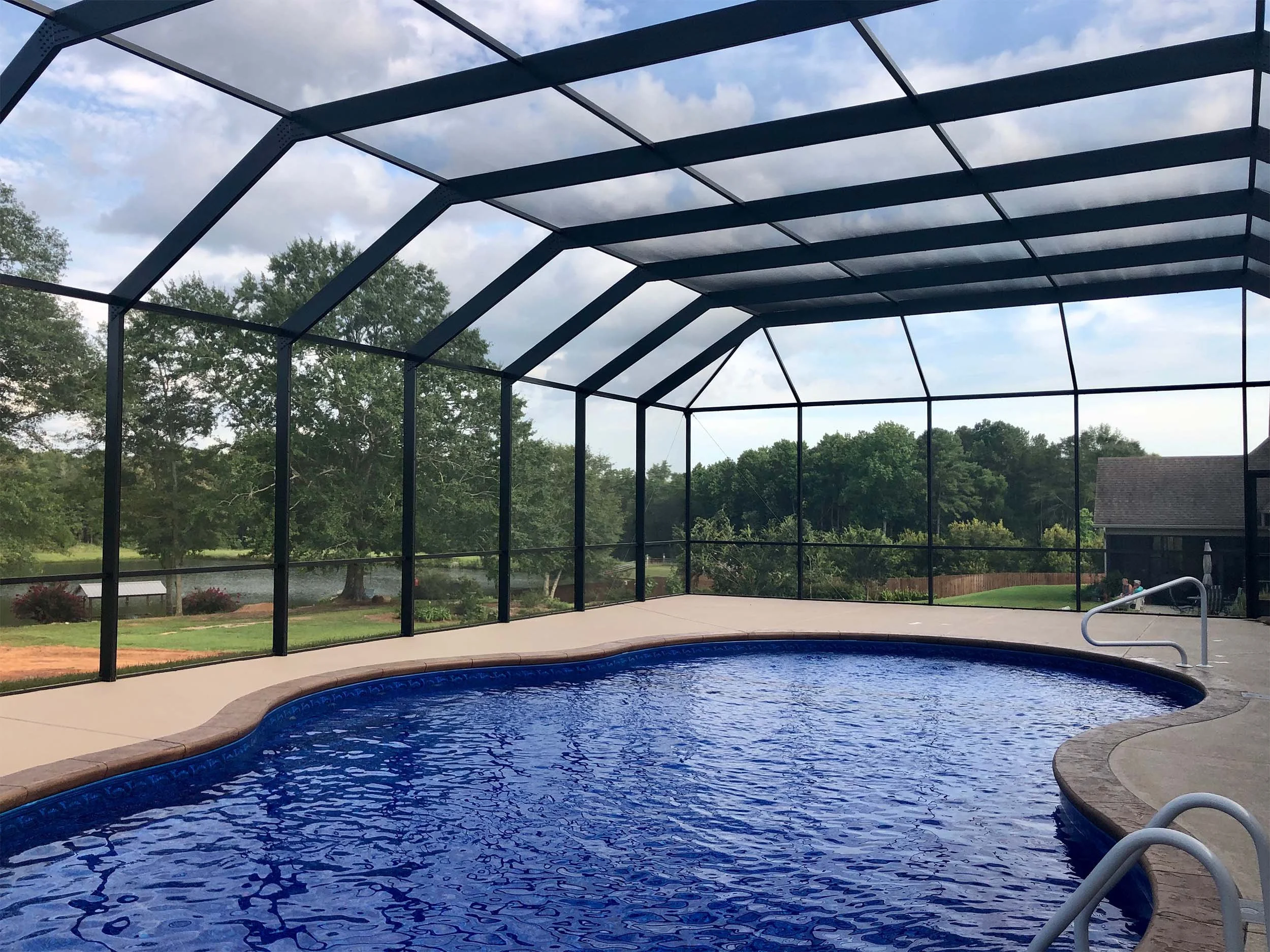 Residential pool enclosure designed to complement the home’s outdoor area.