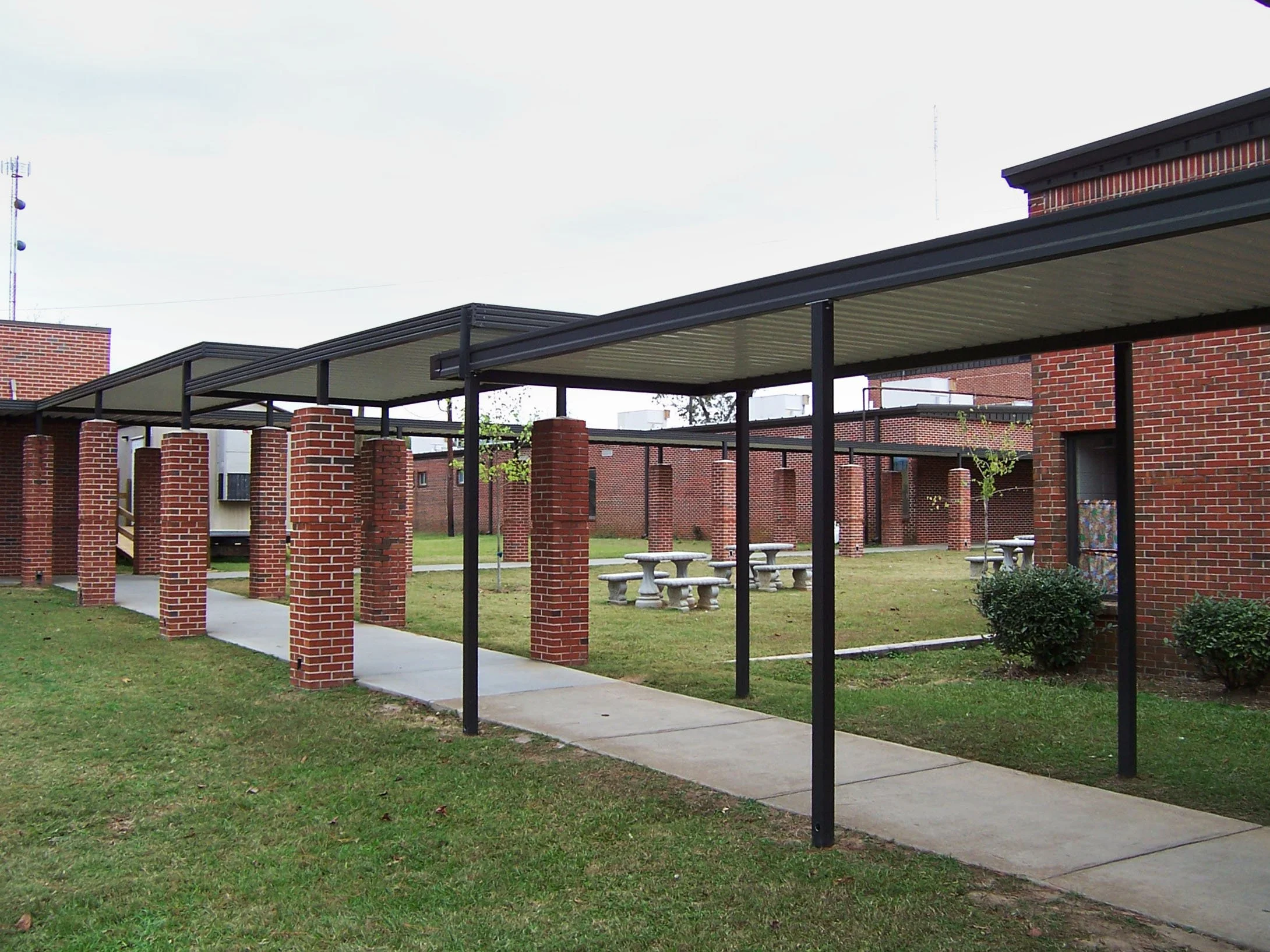 Weather-protected walkway cover designed for schools, businesses, and commercial properties.