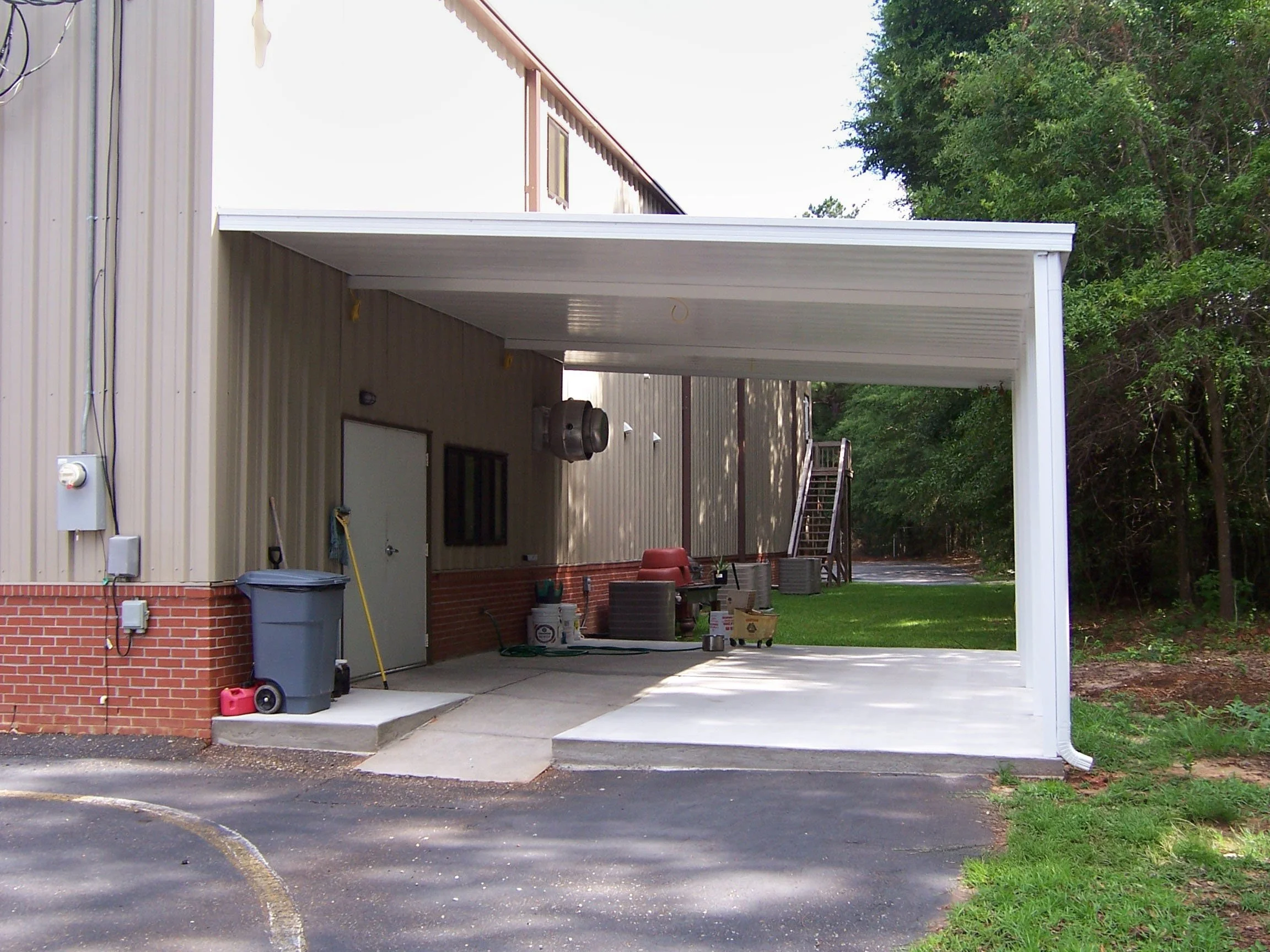 Custom storefront awning designed to protect entrances from sun and rain.