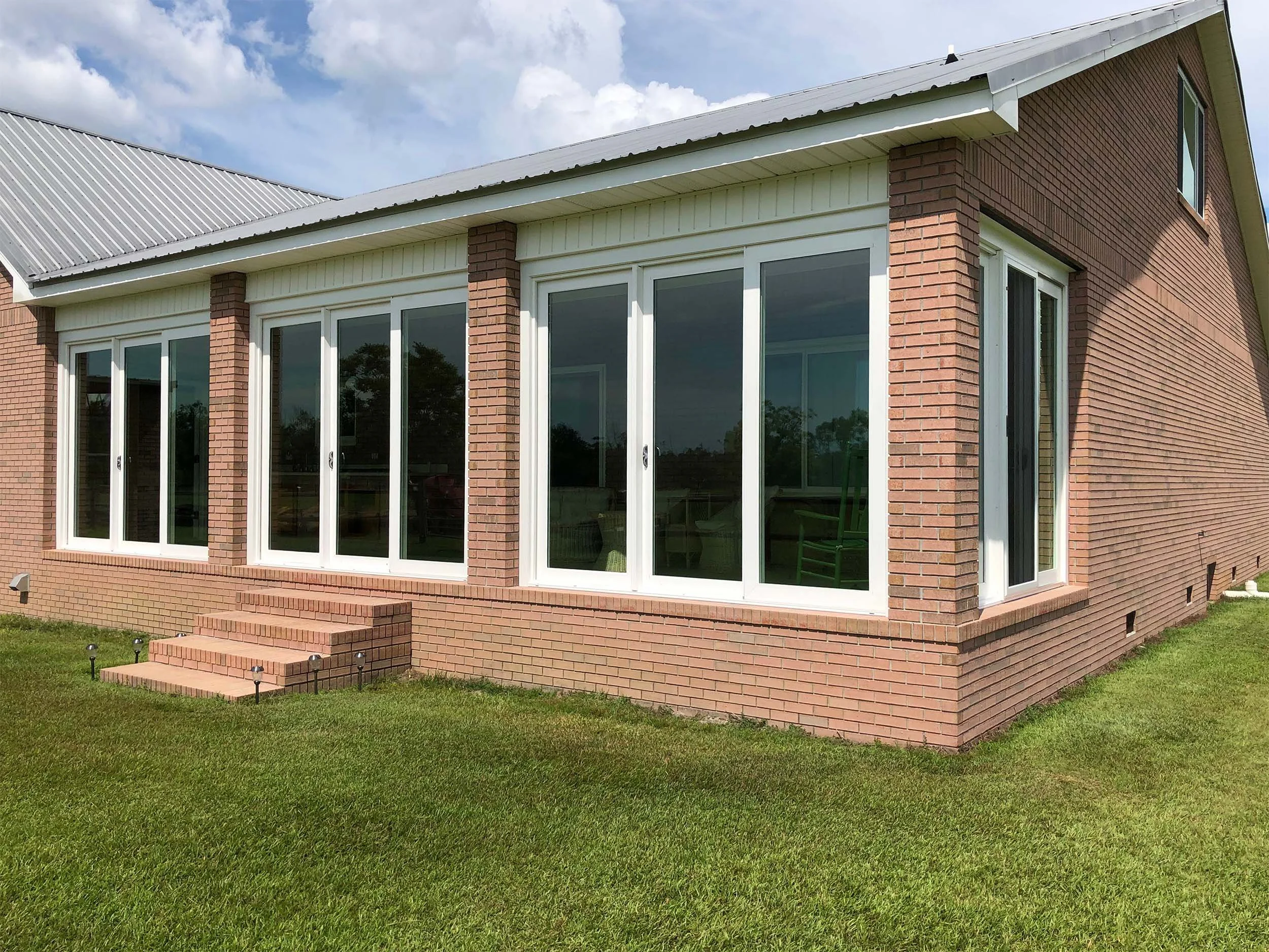 Bright residential sunroom with large windows for comfortable year-round living.