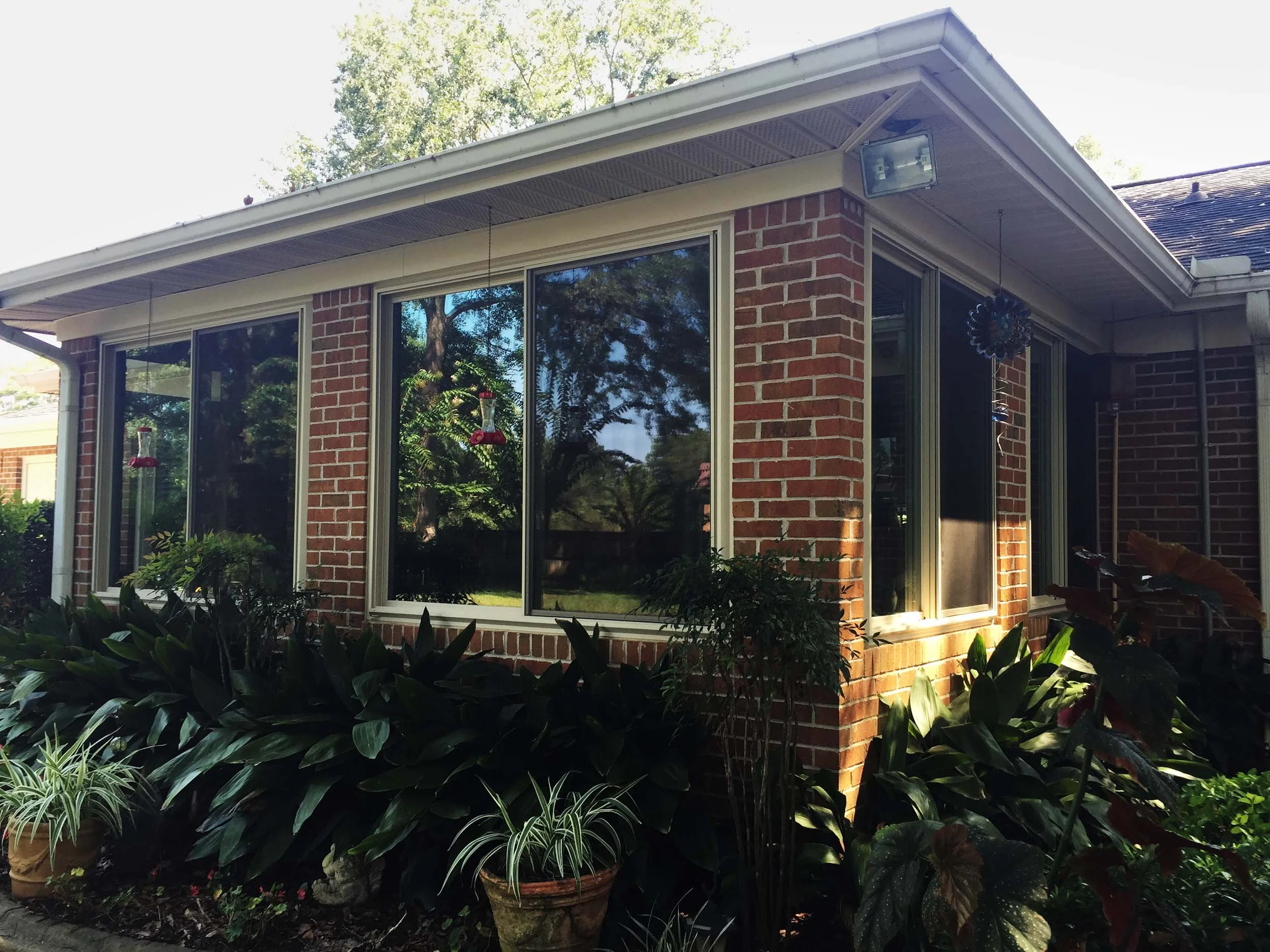 Sunroom with large windows designed to brighten and expand the home.