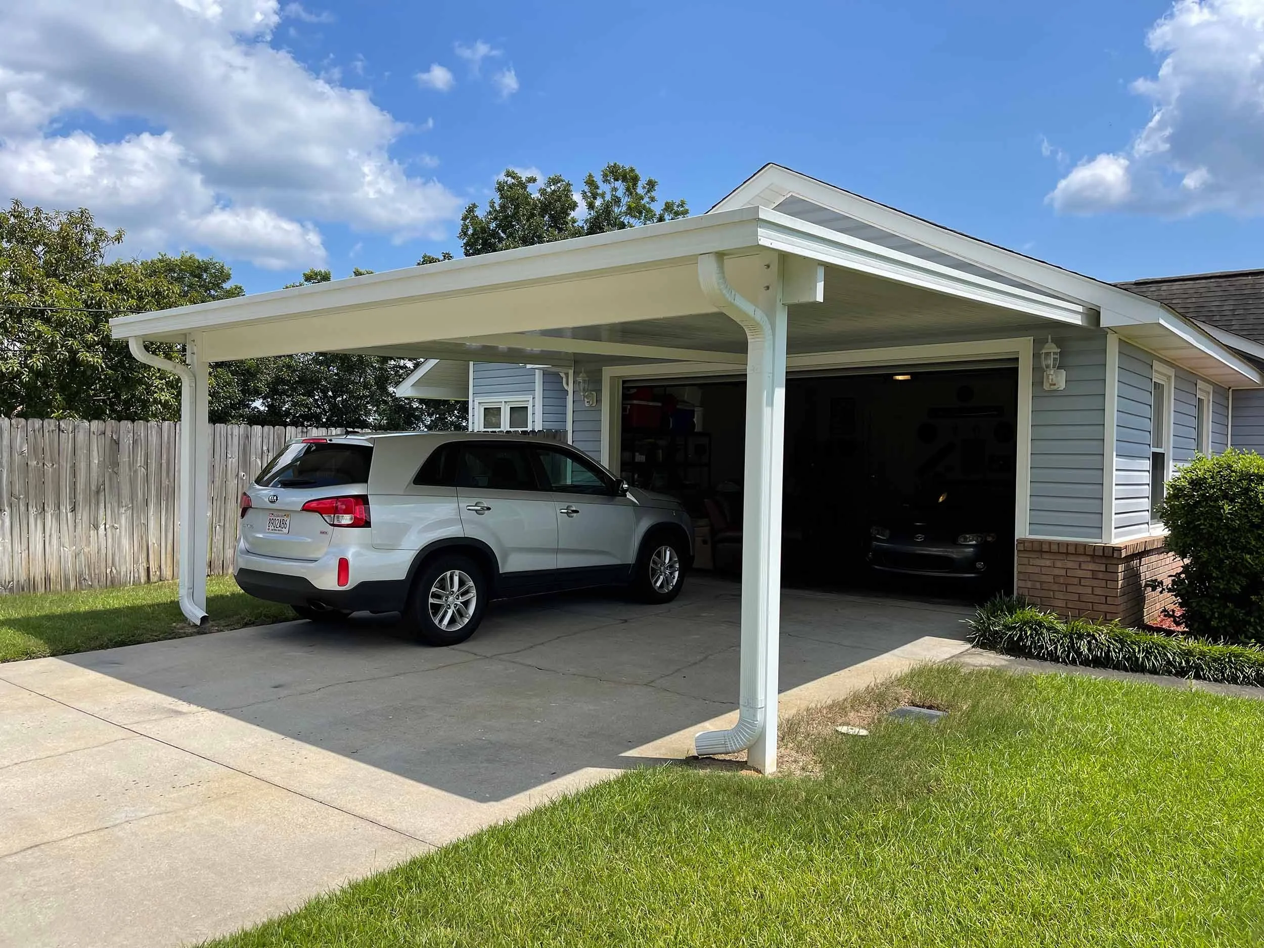 Carport designed to protect vehicles from sun, rain, and weather.