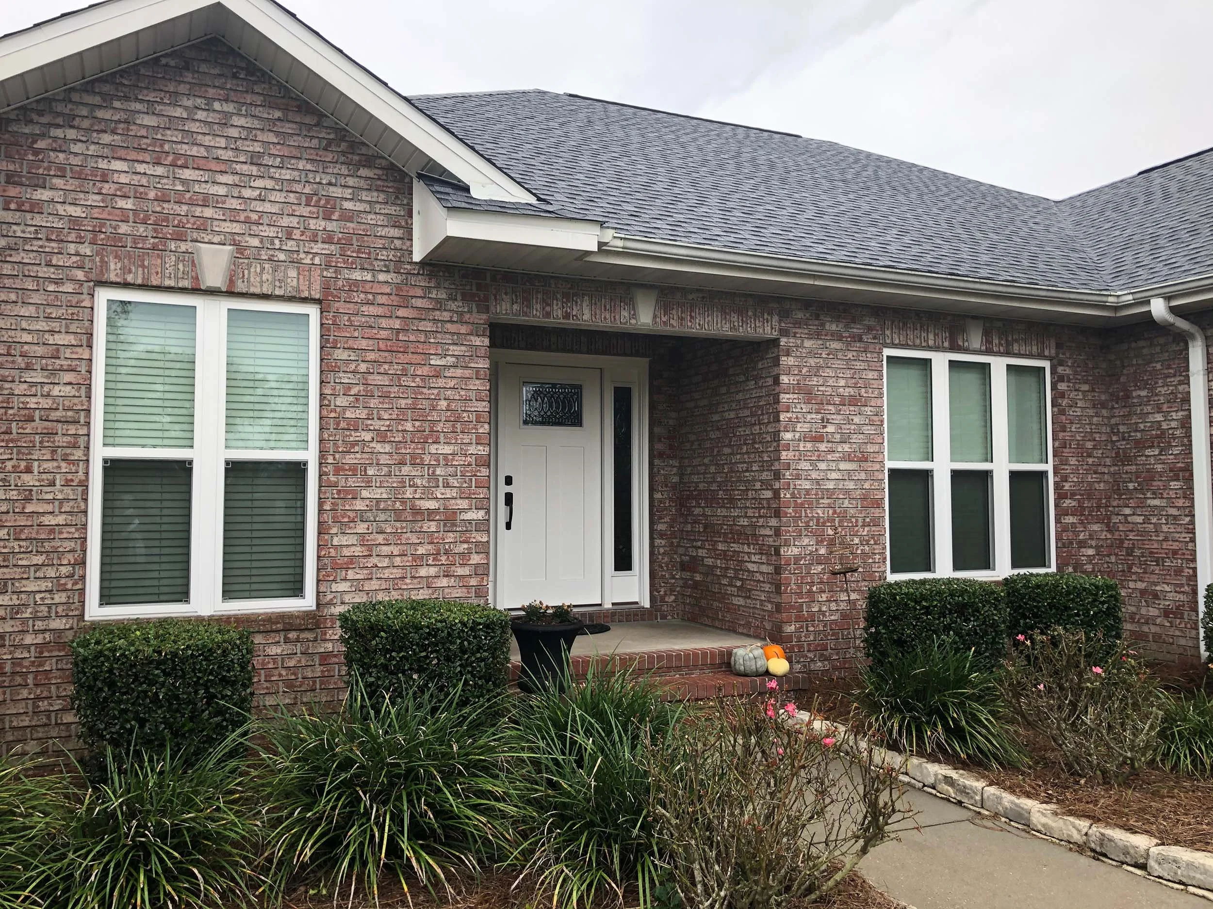 Energy-efficient window replacement for a residential home exterior.