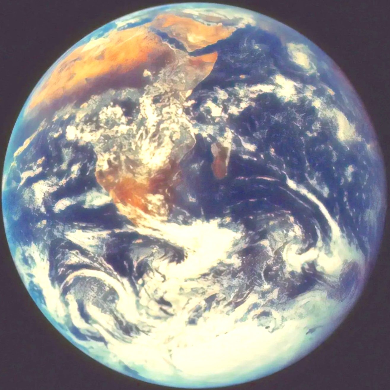 Photograph of Earth from space showing continents, oceans, and cloud patterns.