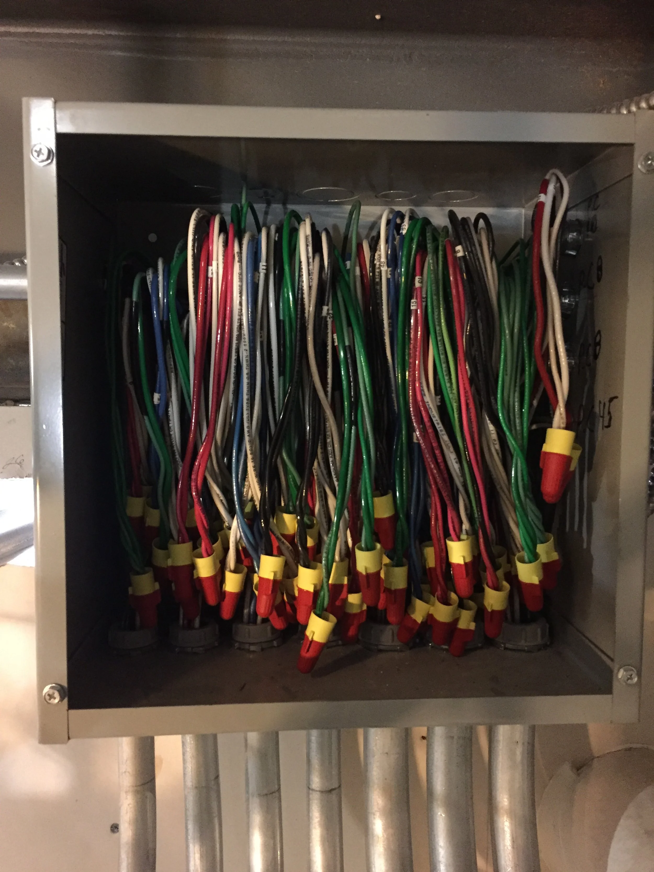 Electrical wires organized inside a metal box.