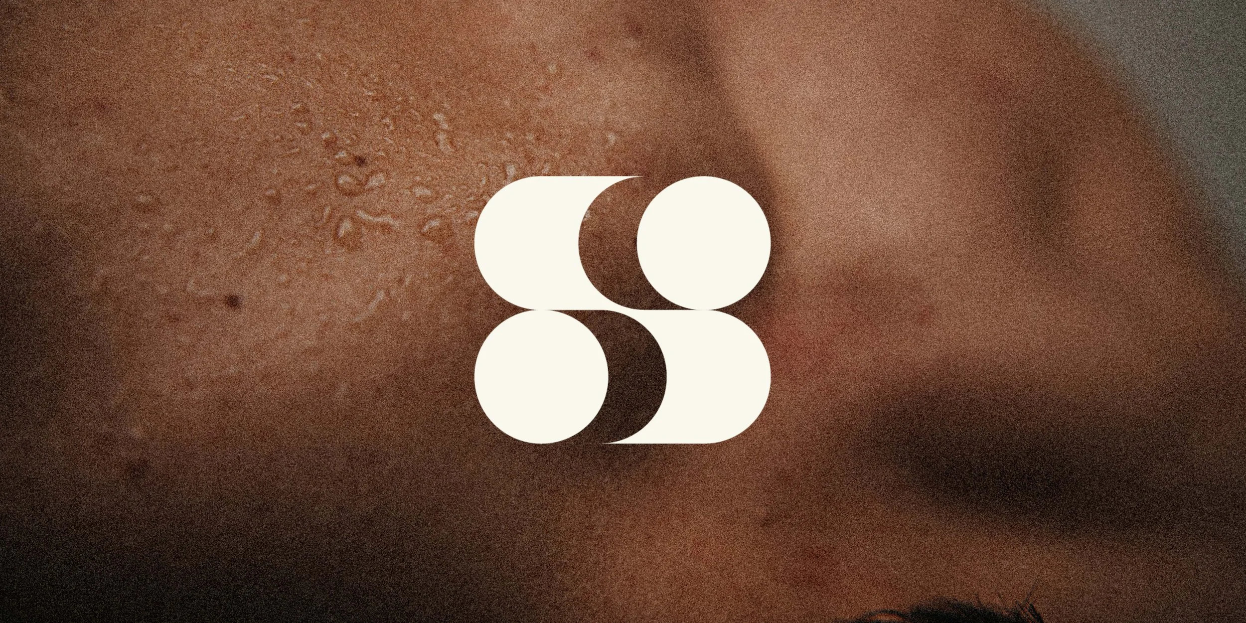 Close-up of a person's skin with sweat droplets.