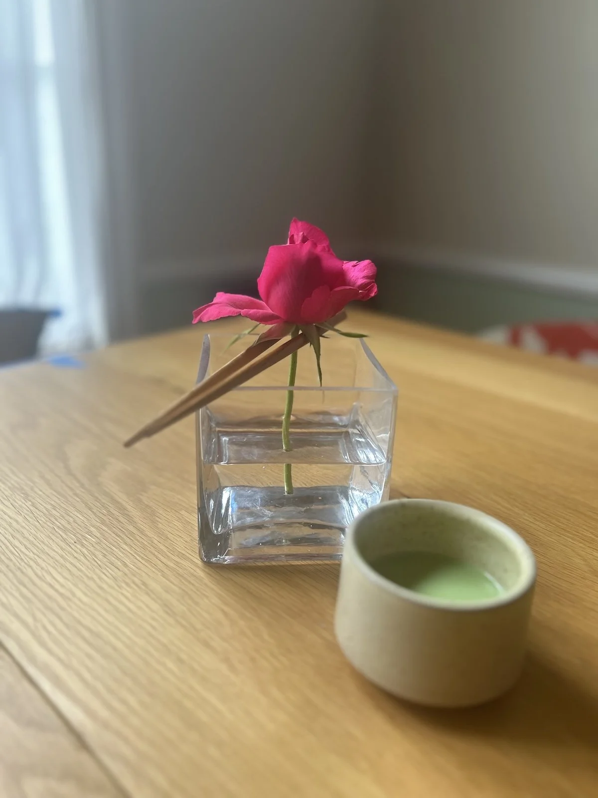 rose vase matcha green tea on table