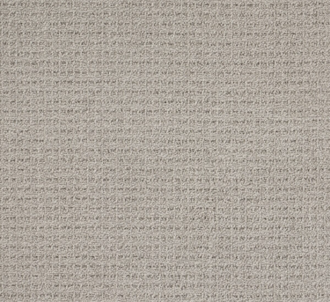 Close-up of a beige textured fabric with a subtle grid pattern.