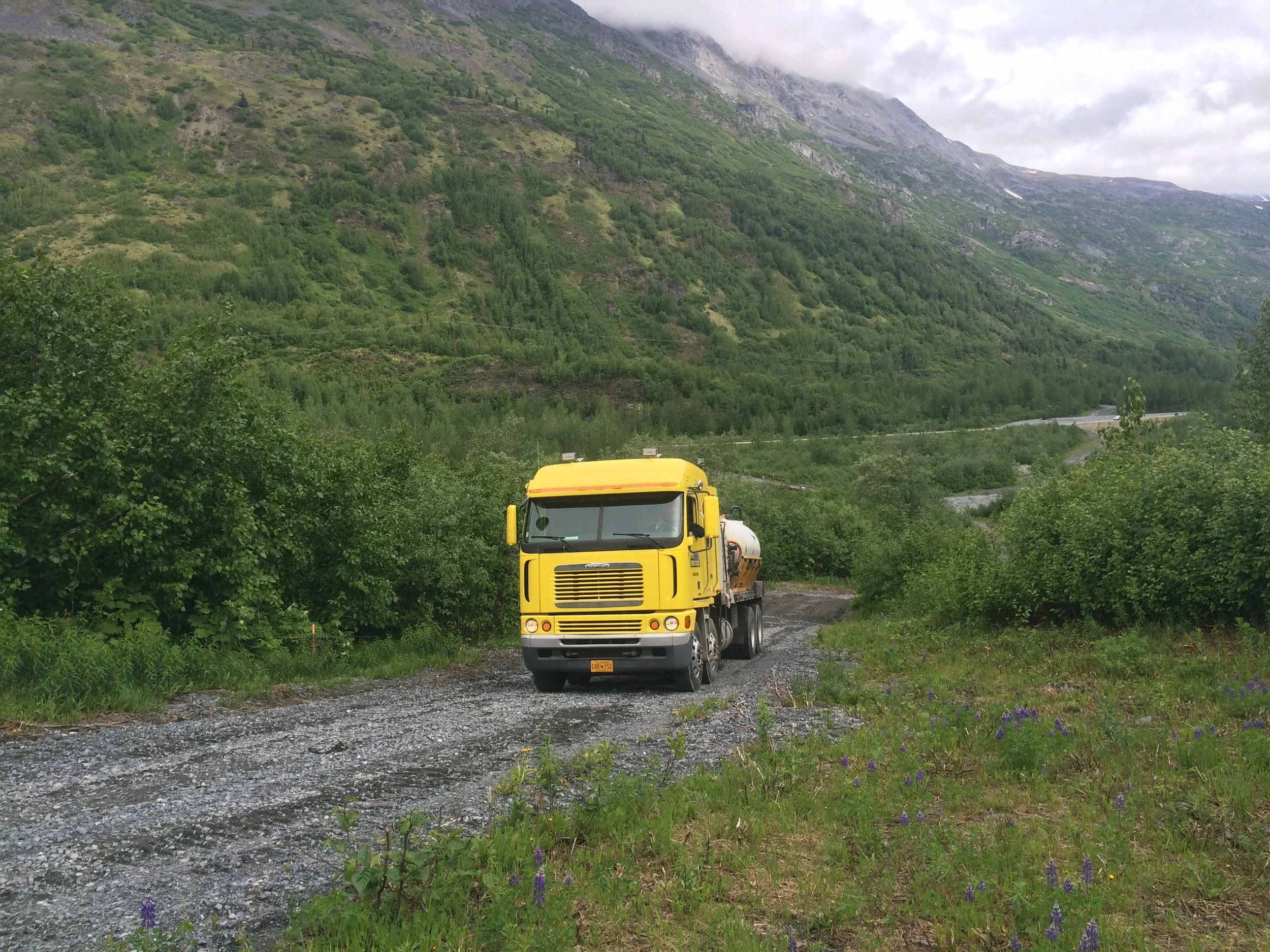 Yellow truck driving in the mountains