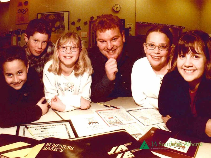 Junior-achievement-Our-business-world-volunteer-with-students-1990s.jpg