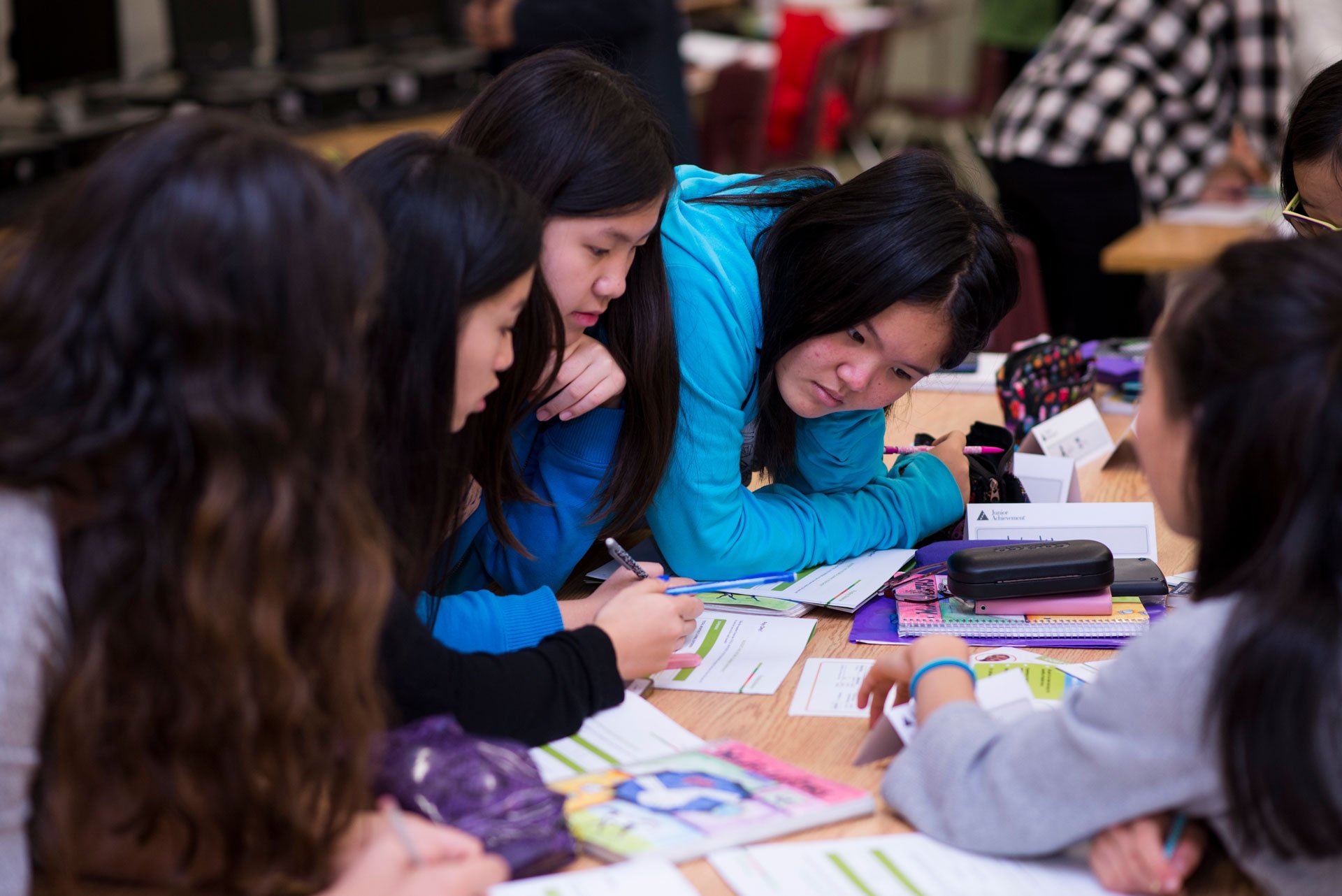 Students collaborating at a table during a JA (Junior Achievement) Southern Alberta program