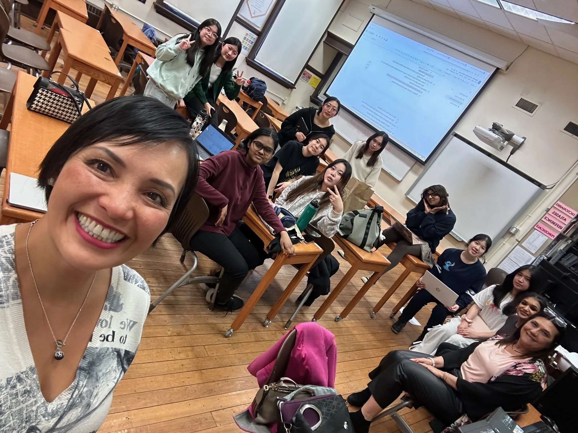 Teacher taking a selfie with students during a JA (Junior Achievement) Southern Alberta classroom program