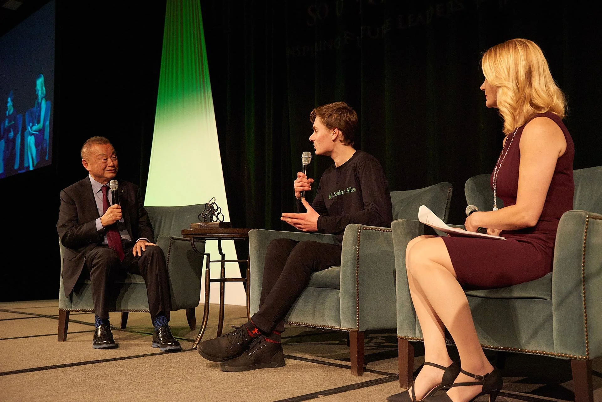 Panel discussion with speakers on stage during a JA (Junior Achievement) Southern Alberta event