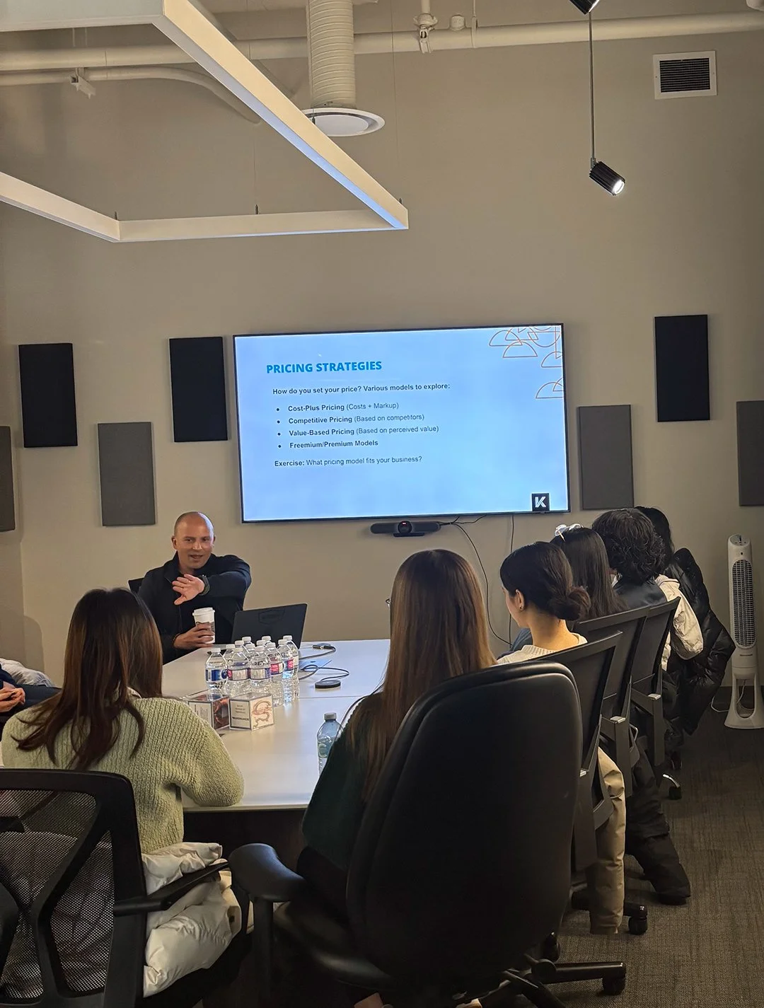 Facilitator presenting pricing strategies during a JA (Junior Achievement) Southern Alberta program