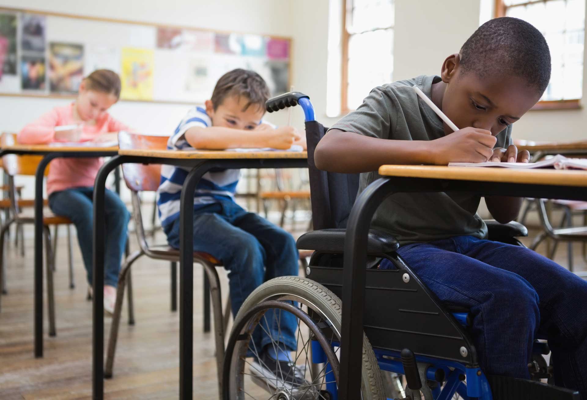 Students participating in a classroom activity during a JA (Junior Achievement) Southern Alberta program, including a student using a wheelchair