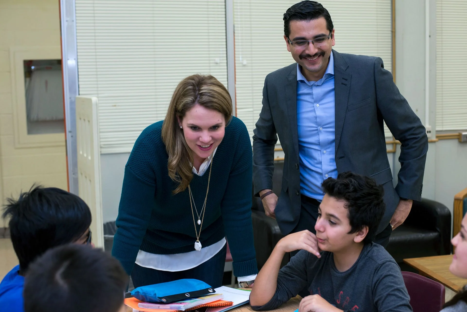 Teacher and volunteer engaging with students during a JA (Junior Achievement) Southern Alberta classroom activity