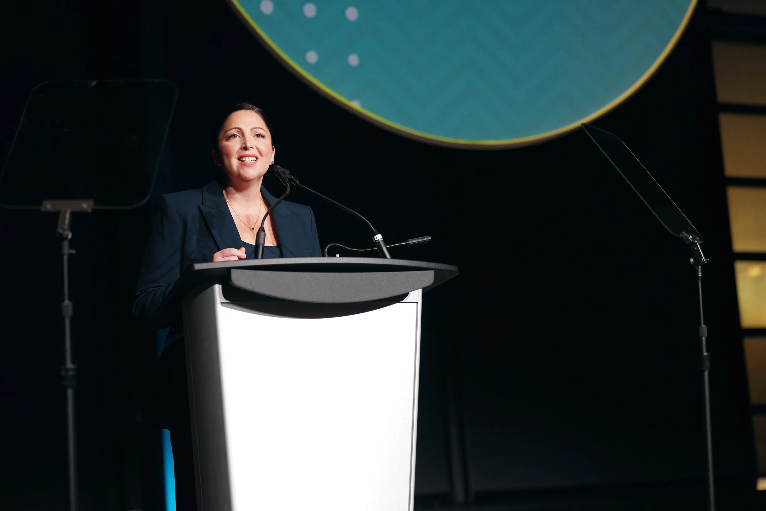 JA (Junior Achievement) Southern Alberta team member speaking to an audience at a gala