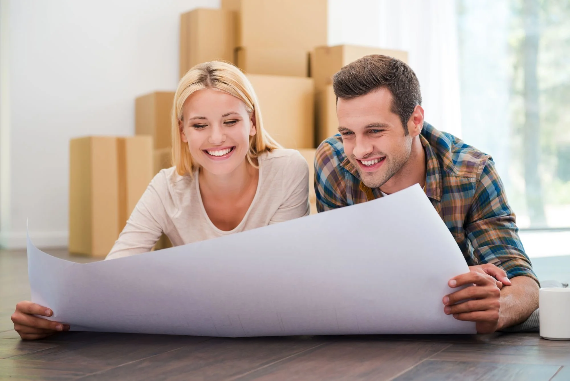 Happy customer looking at construction plans